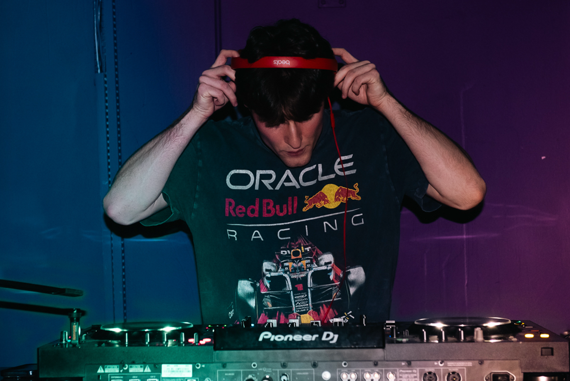 Caption: Toronto DJ Gabe places his headphones on to cue up his next track during a live set at Bar Serene in Toronto on Sunday, Feb. 8, 2026. He played an extended midnight set that drew a massive, energetic reaction from fans. Camera Settings: 1/60, ISO 2800, f/2.8