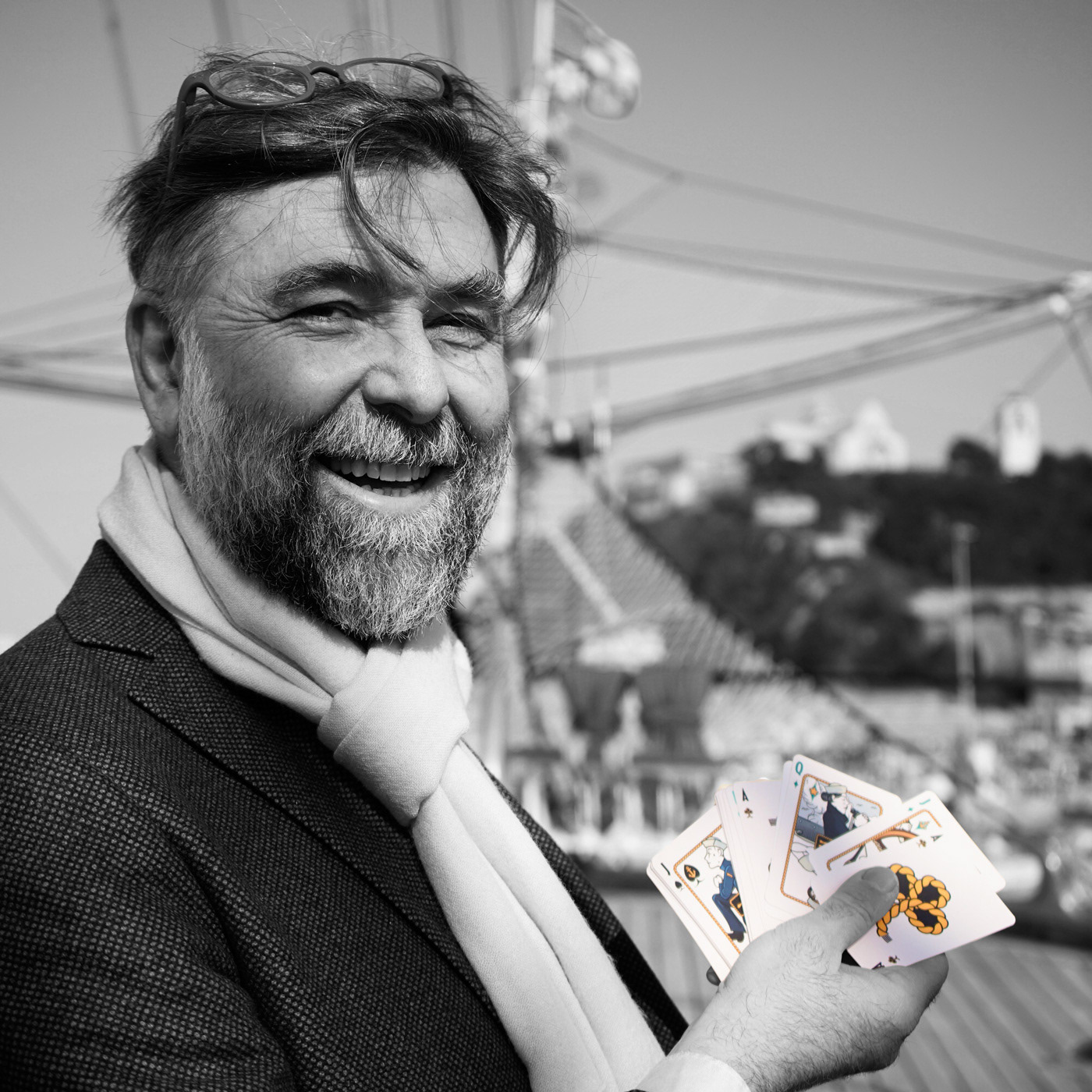 Ardo Quaranta holding the Divinissimi Assi playing cards aboard the Amerigo Vespucci, Italian Navy training ship.