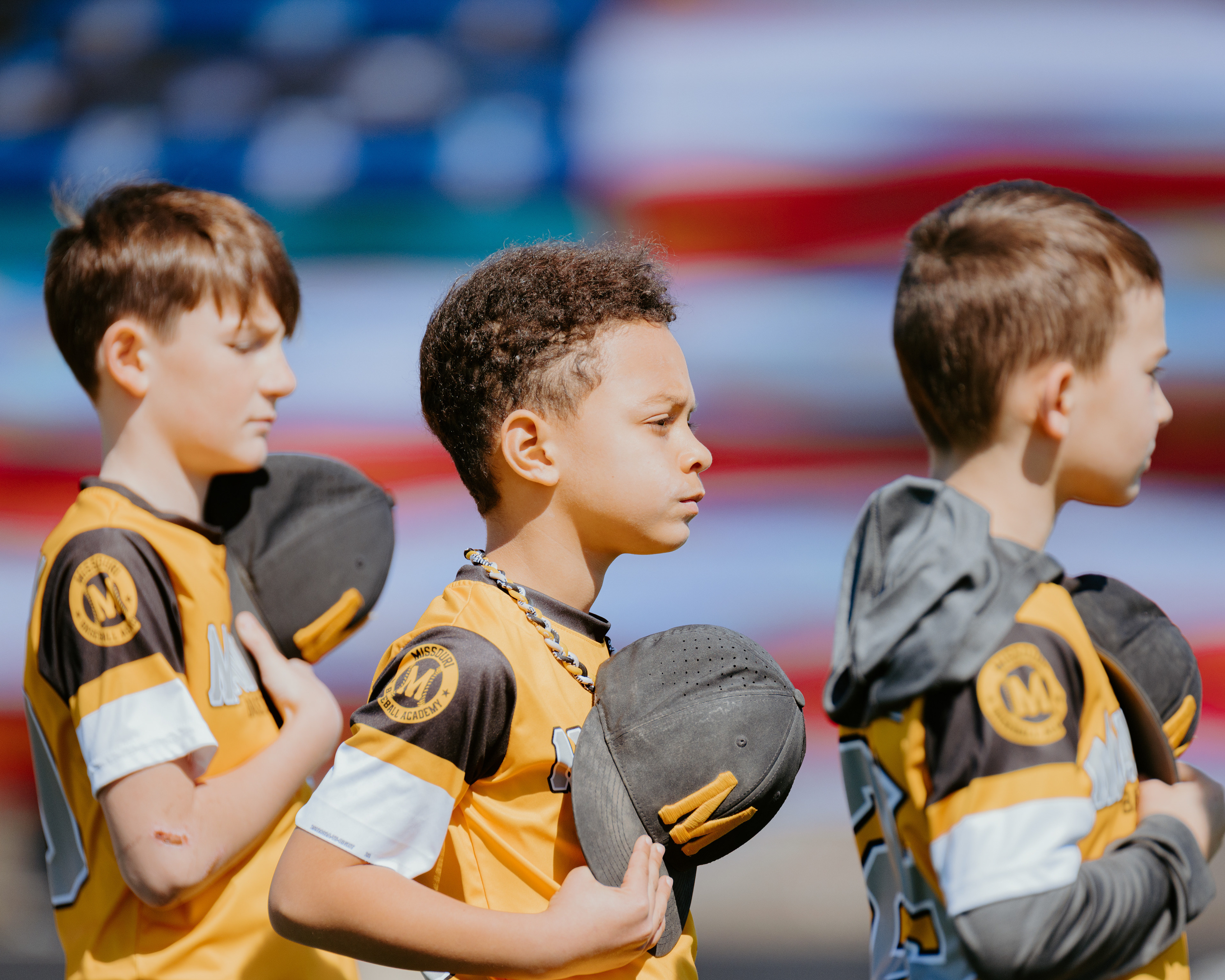 A youth baseball team stands for the national anthem at Taylor Stadium on March 8, 2026, in Columbia, Missouri.