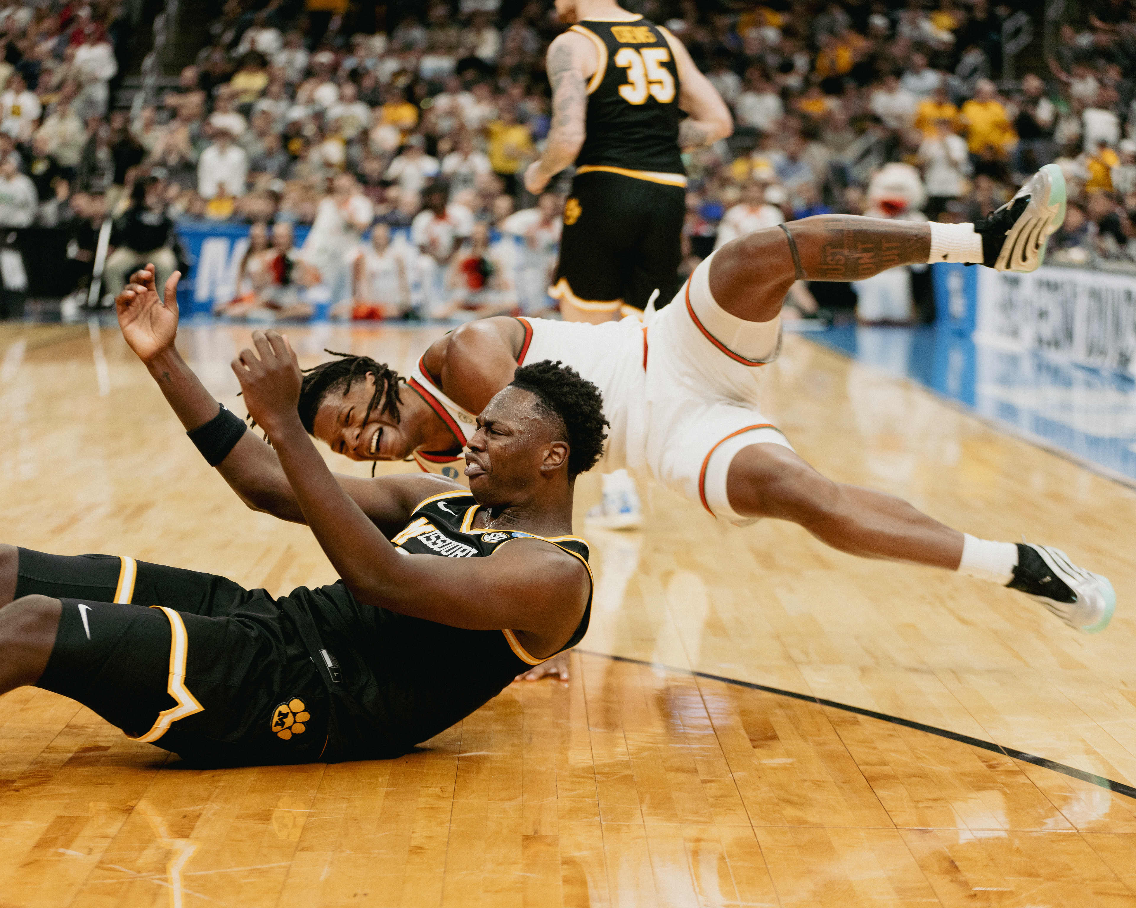 Mizzou forward Mark Mitchell (25) looks for a foul call from the referee as Miami Hurriances' Shelton Henderson (7) falls from contact at the Enterprise Center on March 20, 2026 in Saint Louis, Missouri.