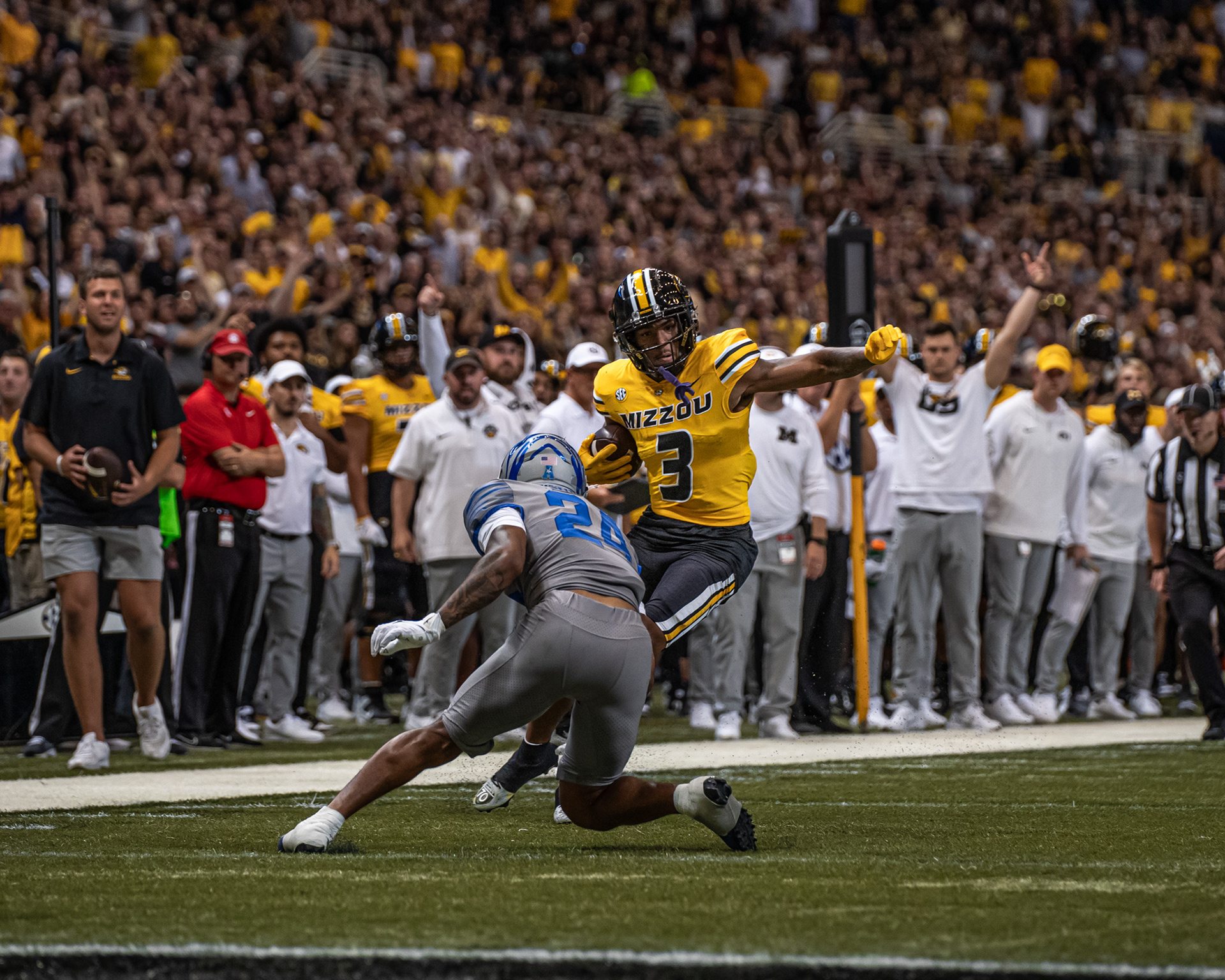 From left, Memphis defensive back Greg Rubin (24) attempts to tackle Mizzou wide receiver (3) at the Dome at America’s Center on Sept. 23, 2023, in St. Louis, Mo.