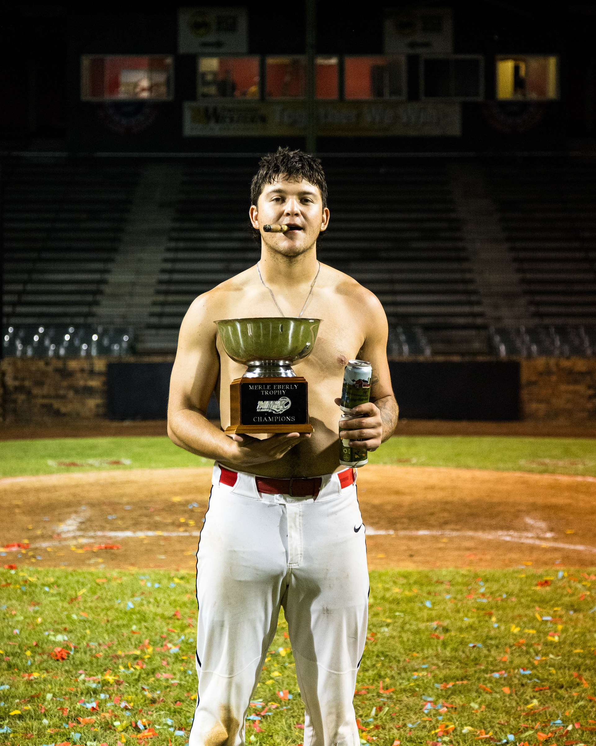 Dom Felix holds the MINK League championship trophy and two Busch Lights