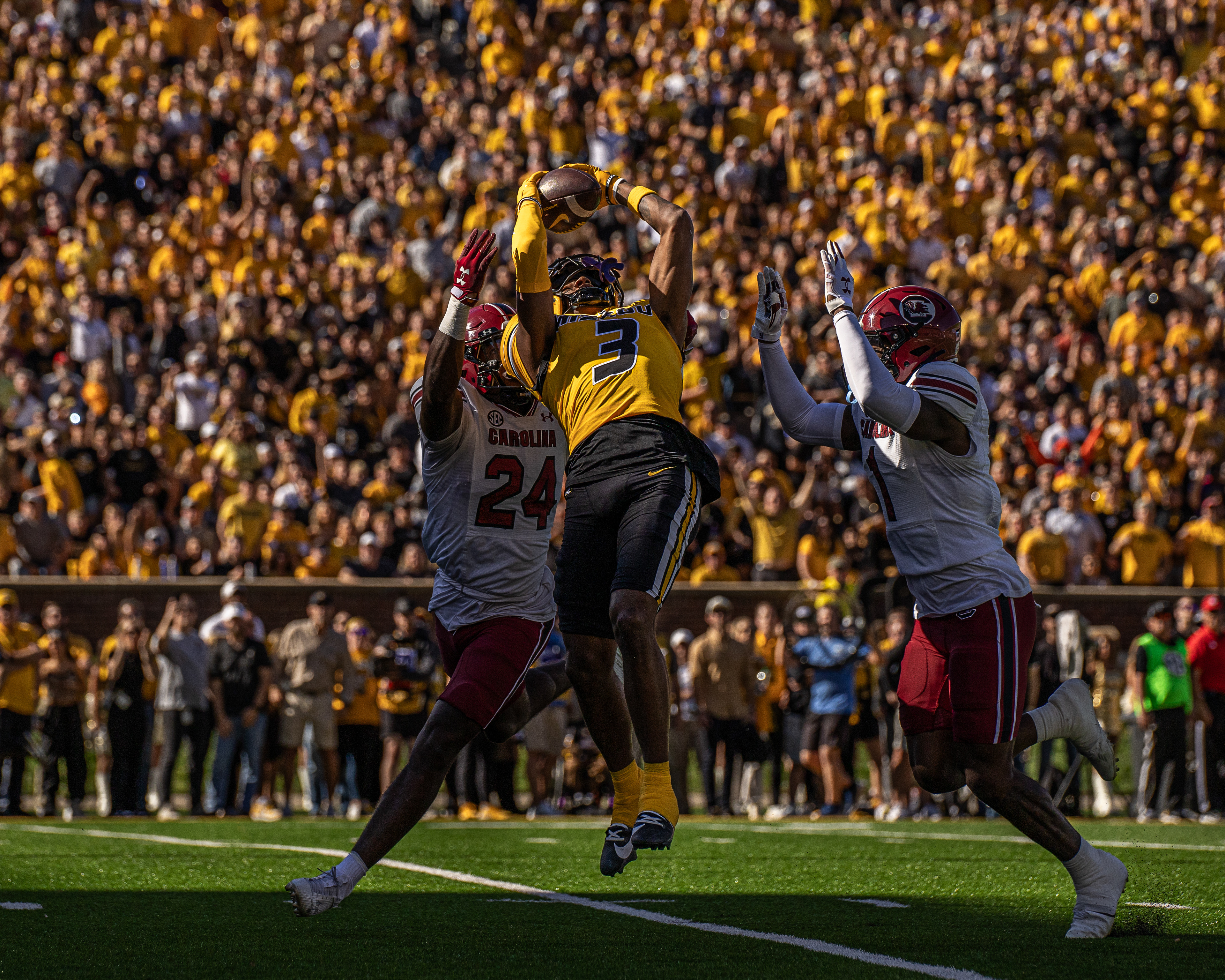 From left, South Carolina defensive backs Jalon Kilgore (24) and DQ Smith (1) attempt to intercept a ball passed to Mizzou wide receiver Luther Burden (3) at Memorial Stadium on Oct. 21, 2023, in Columbia, Mo.