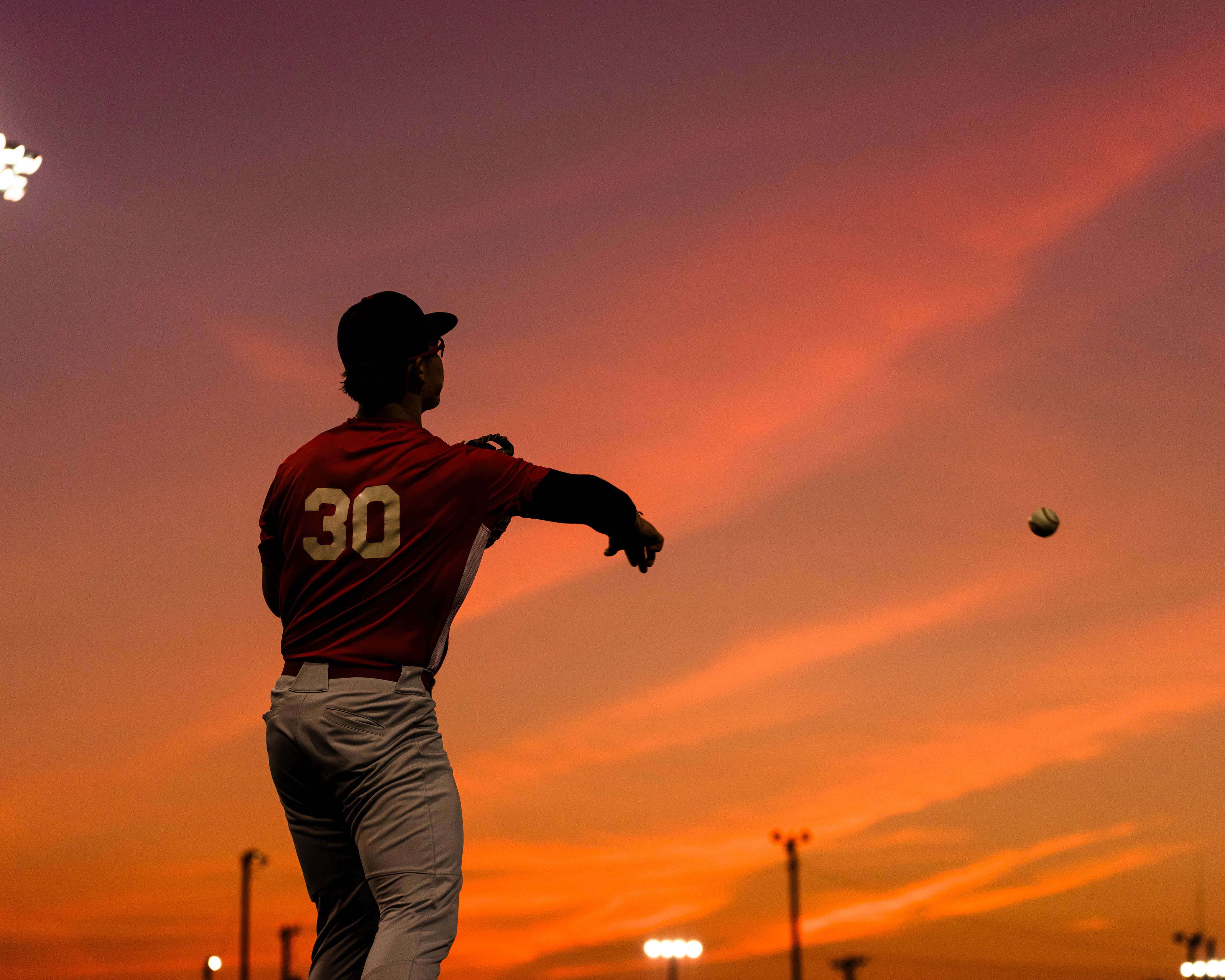 Justin George throws a practice ground ball to one of his infielders