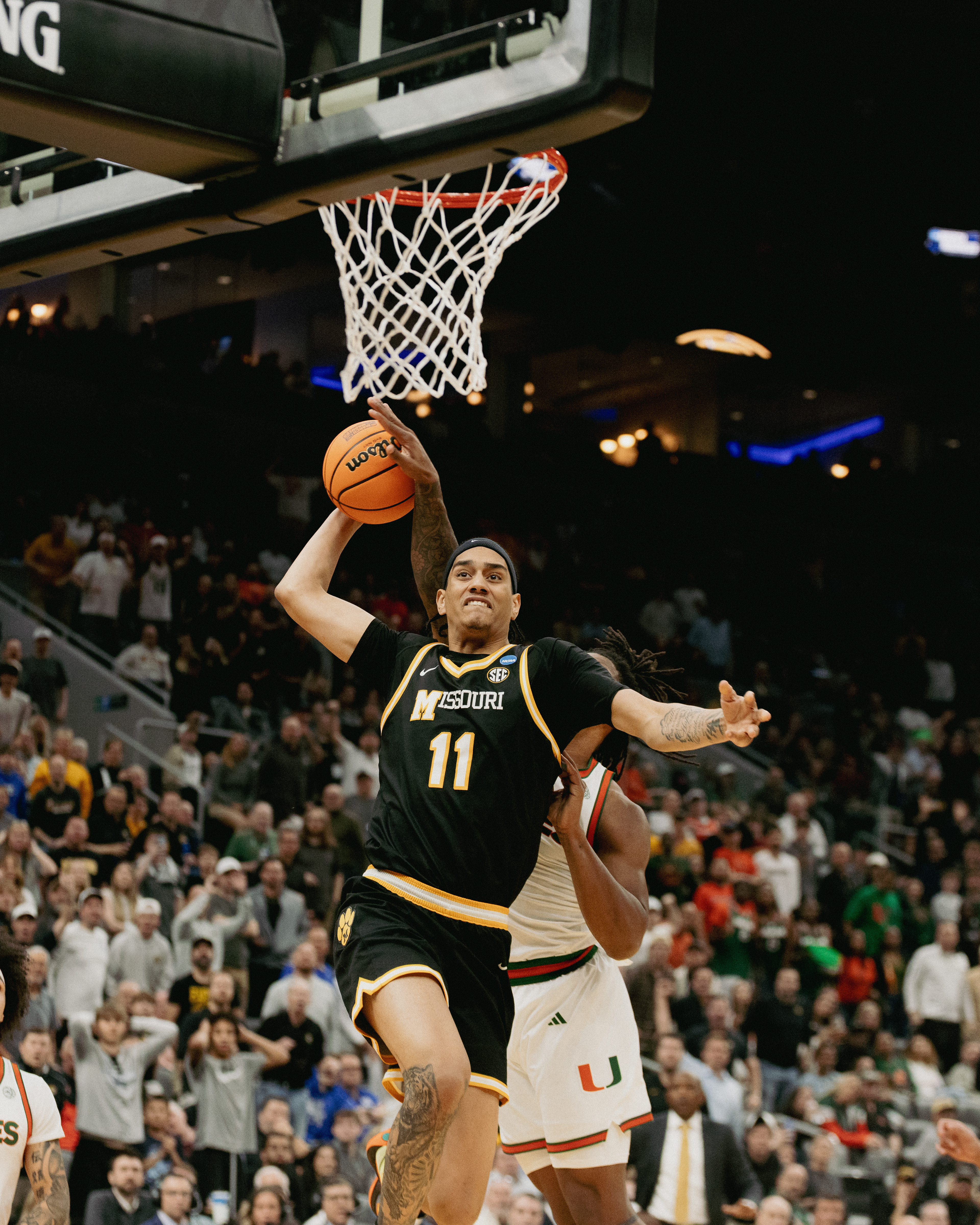 Mizzou guard Trent Pierce (11) is denied a dunk by a Miami (FL) defender at the Enterprise Center on March 20, 2026 in Saint Louis, Missouri.