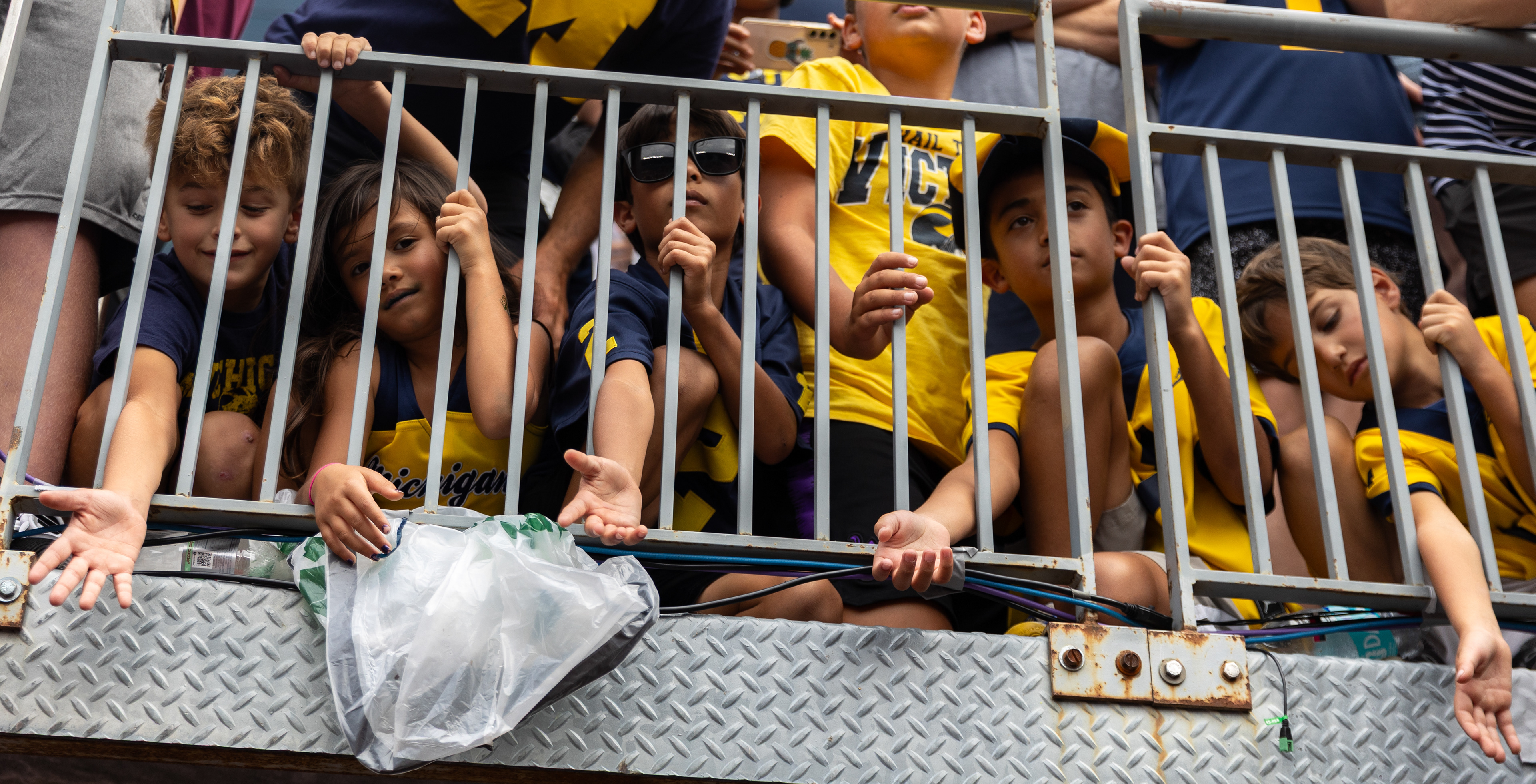 Children reach their hands out in the Lloyd Carr Tunnel for University of Michigan players at the end of the game against Central Michigan University in Michigan Stadium in Ann Arbor, MI, Saturday, Sept. 13, 2025. UofM defeated CMU 63-3. 