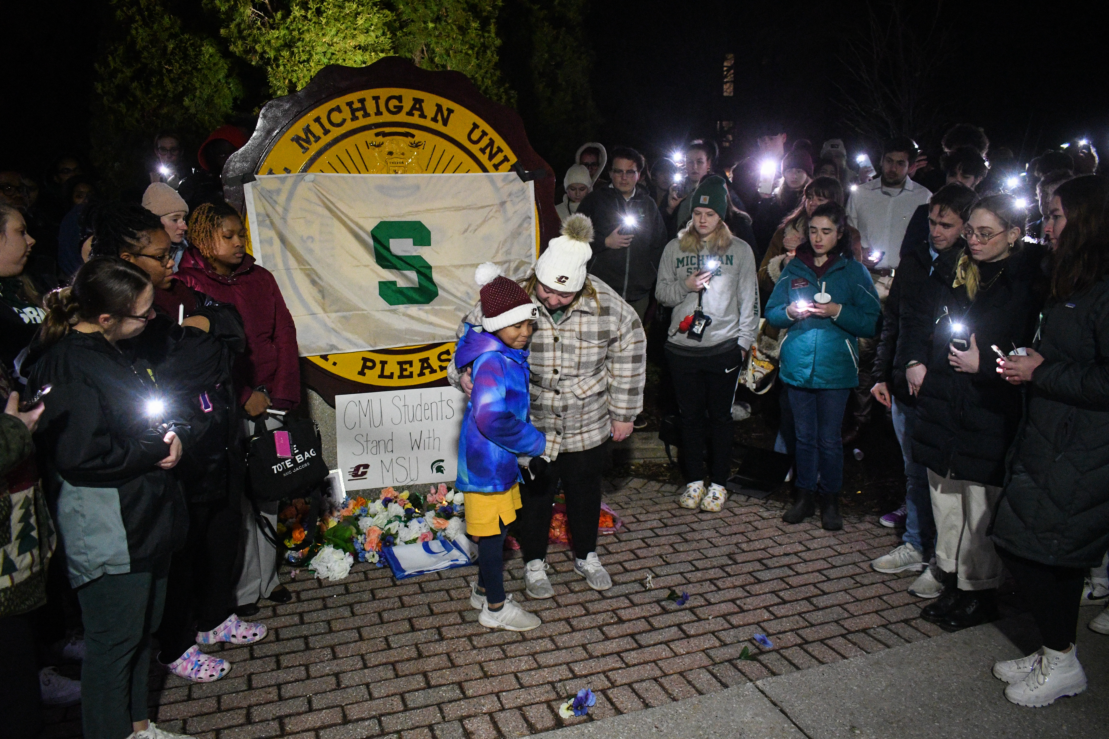 A pair of sisters talk about their experiences with hearing about the MSU shooting and share their emotions at the Central Michigan University Seal outside of Warriner Hall in Mount Pleasant, Michigan, Wednesday, Feb. 15, 2023.