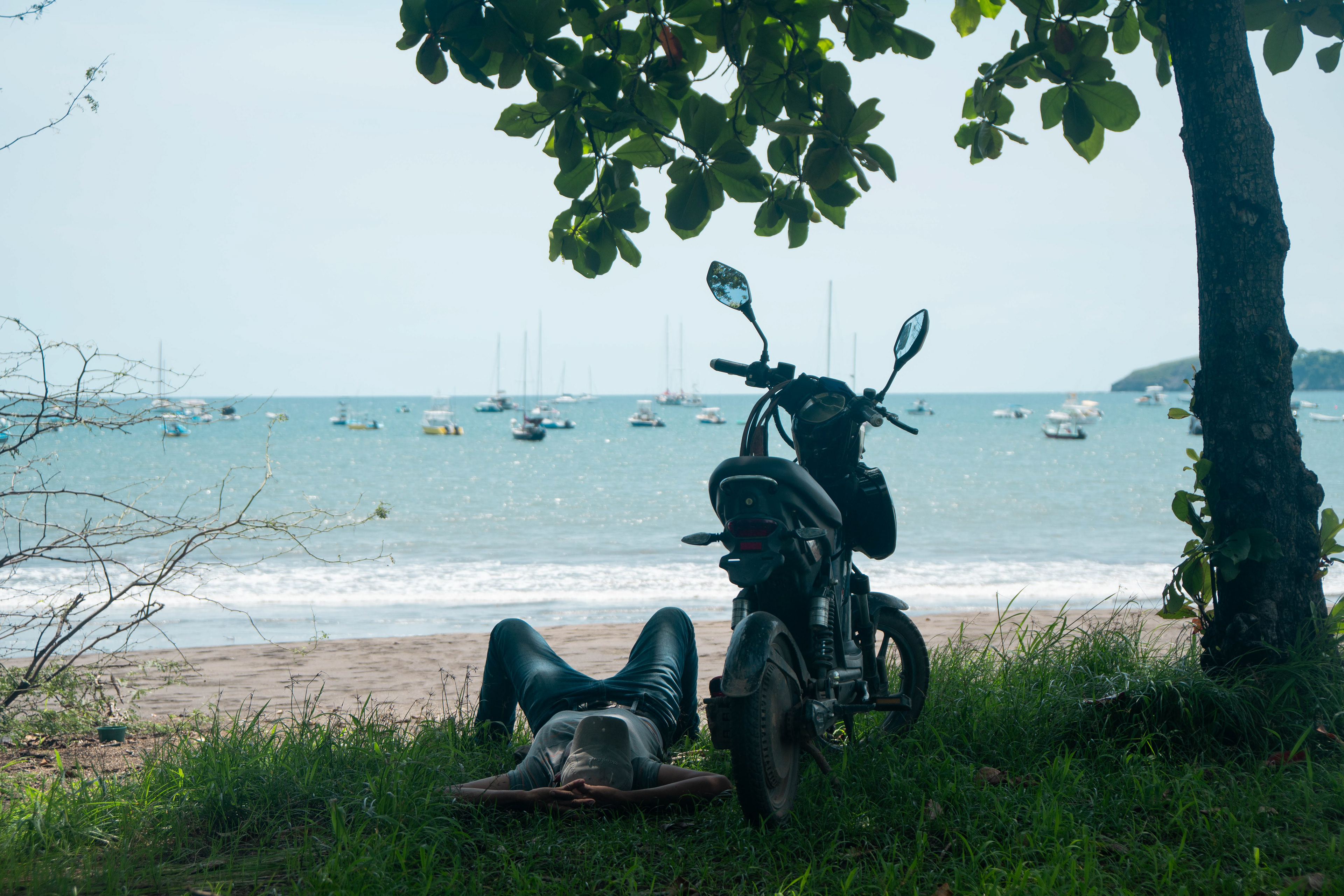 Motorcyclist resting in the shade, Costa Rica.