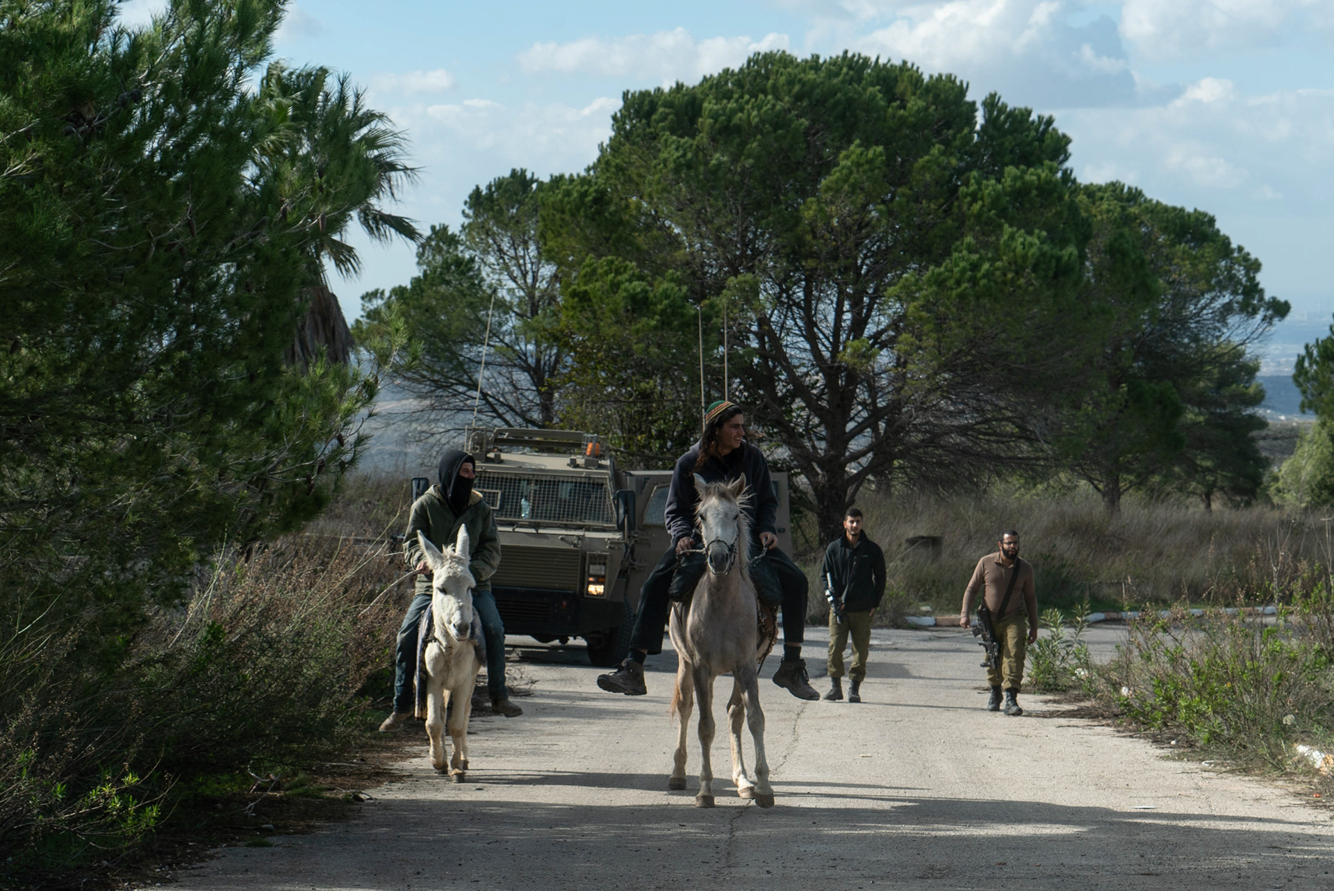 Settlers and soldiers near the formerly evacuated settlement of Homesh.