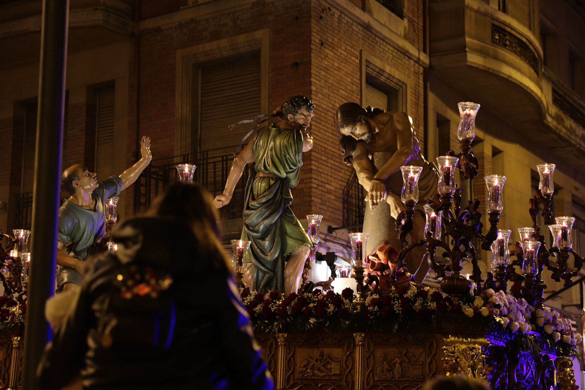 A kid watches as members of the Flagellation Brotherhood carry the Penitential 'Via Crucis' of the Flagellation passage during the procession on Holy Tuesday in Logrono, La Rioja, Spain, April 04, 2023.