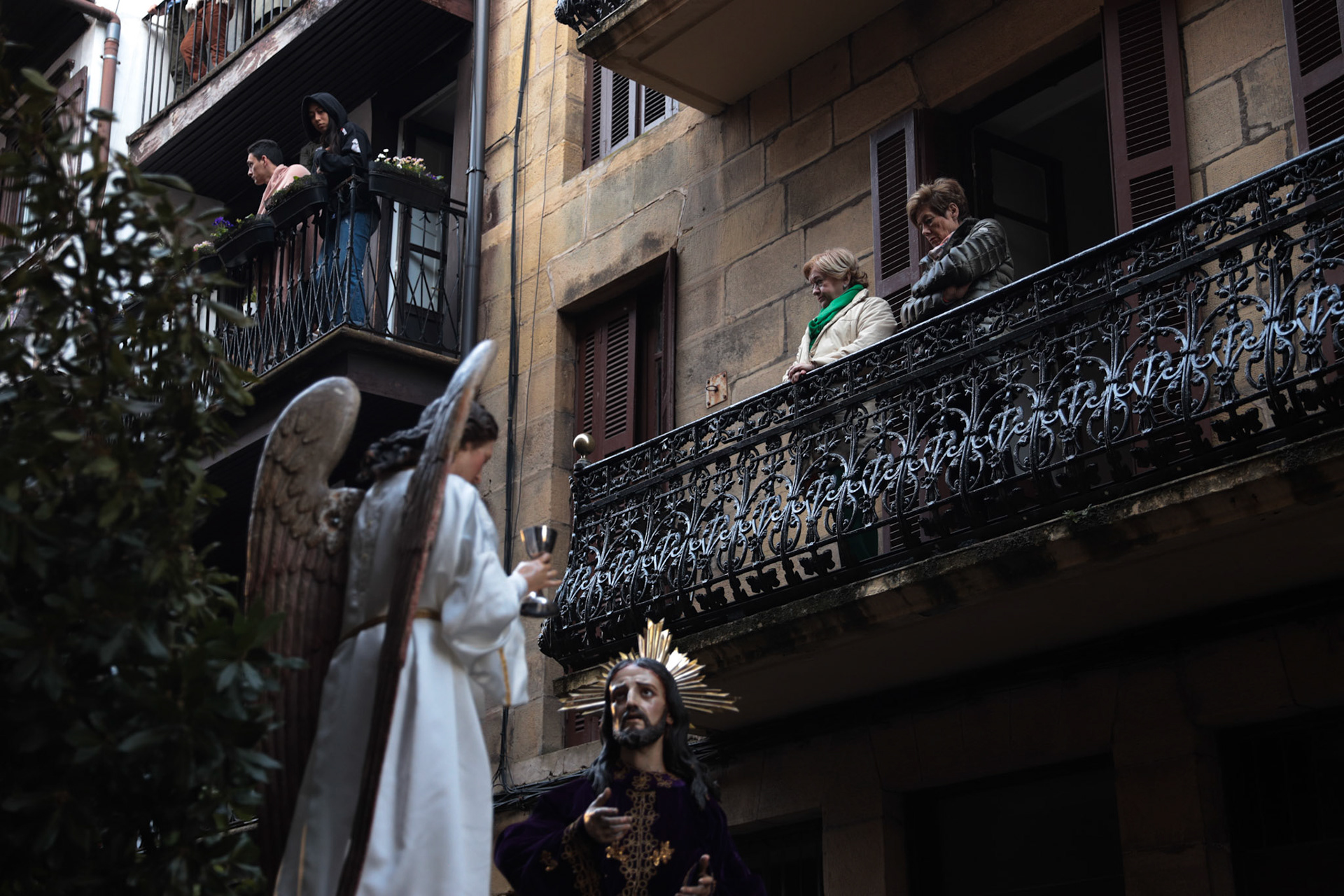 People watch the Silent Procession and Holy Sepulchre of the Recumbent Christ on Good Friday from their houses in Hondarribia, Gipuzkoa, Basque Country, Spain, April 08, 2023.
