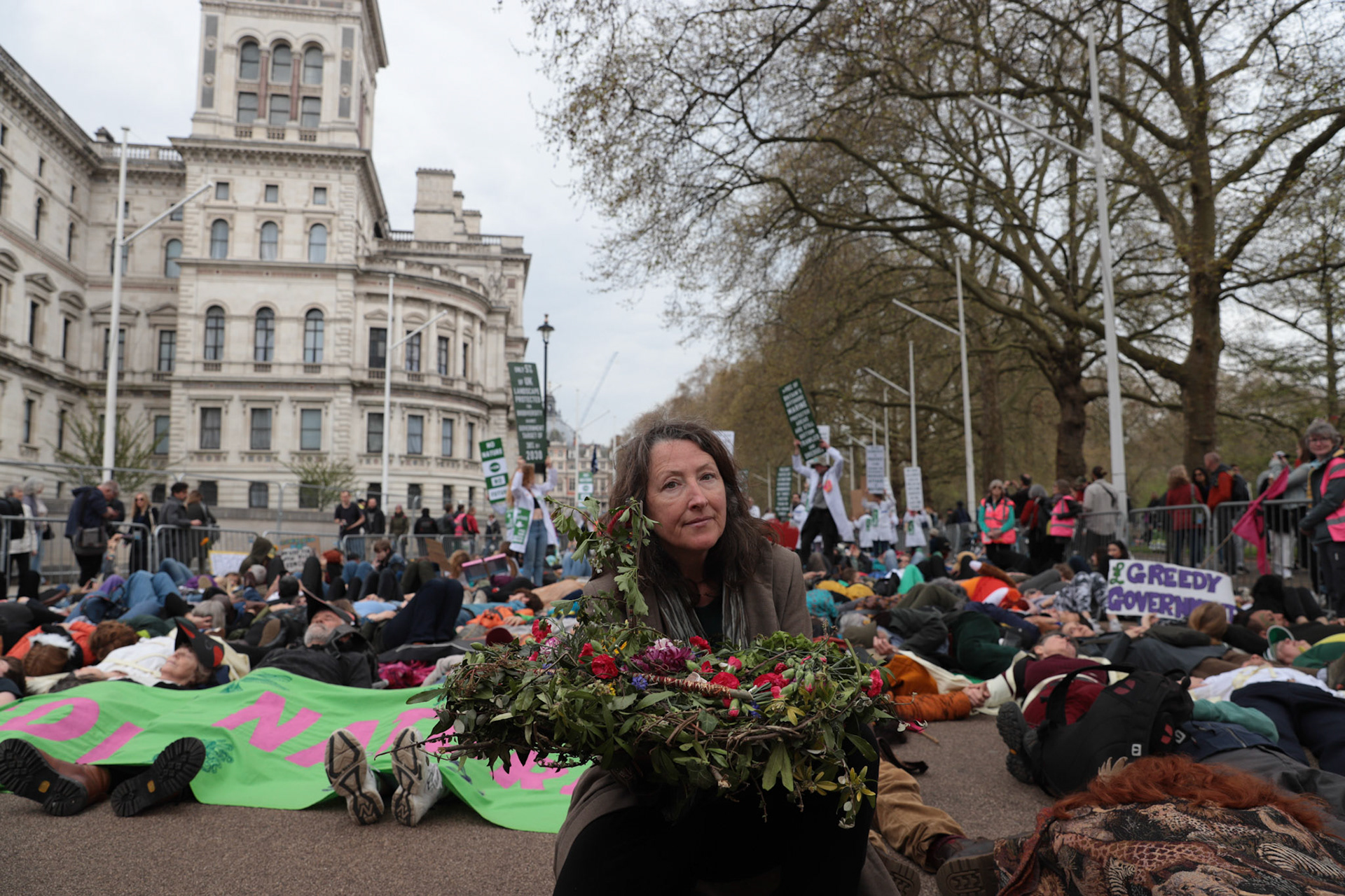 People participate in a staged 'die-in' during 'The Big One' protest and march organized by Extinction Rebellion in Central London, Britain, April 22, 2023.
