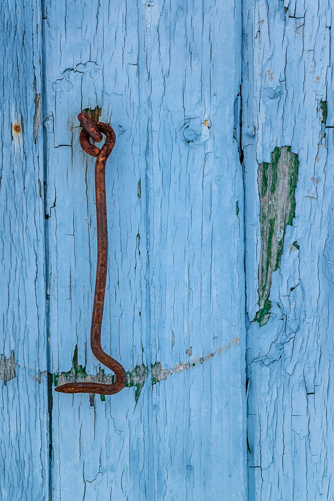An interesting door detail, featuring an orange/blue colour contrast and a pattern of wear that the mind understands as resulting from many years of use.
