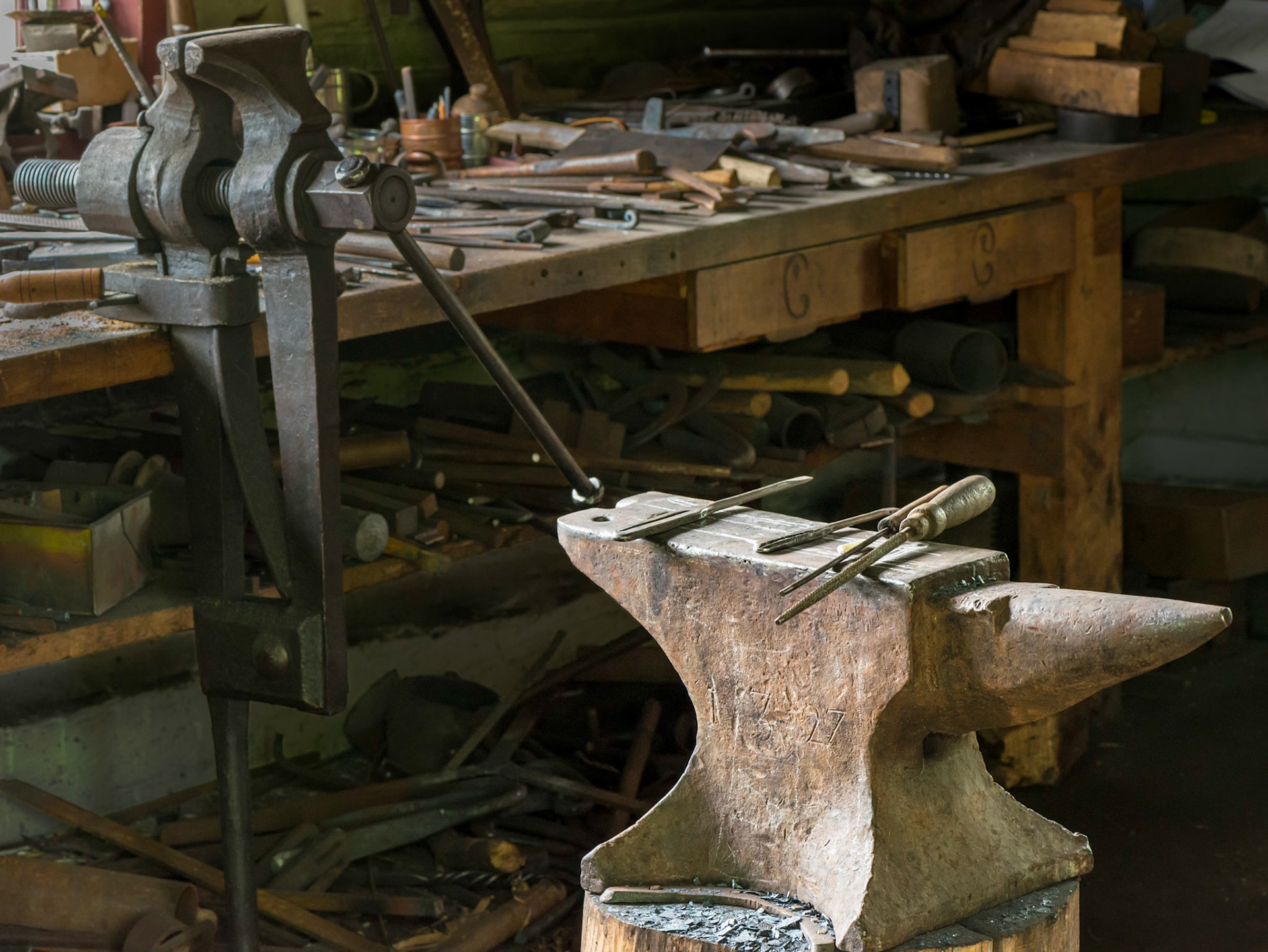 While the blacksmith's workroom is quite cluttered, I found the anvil and its markings especially interesting.