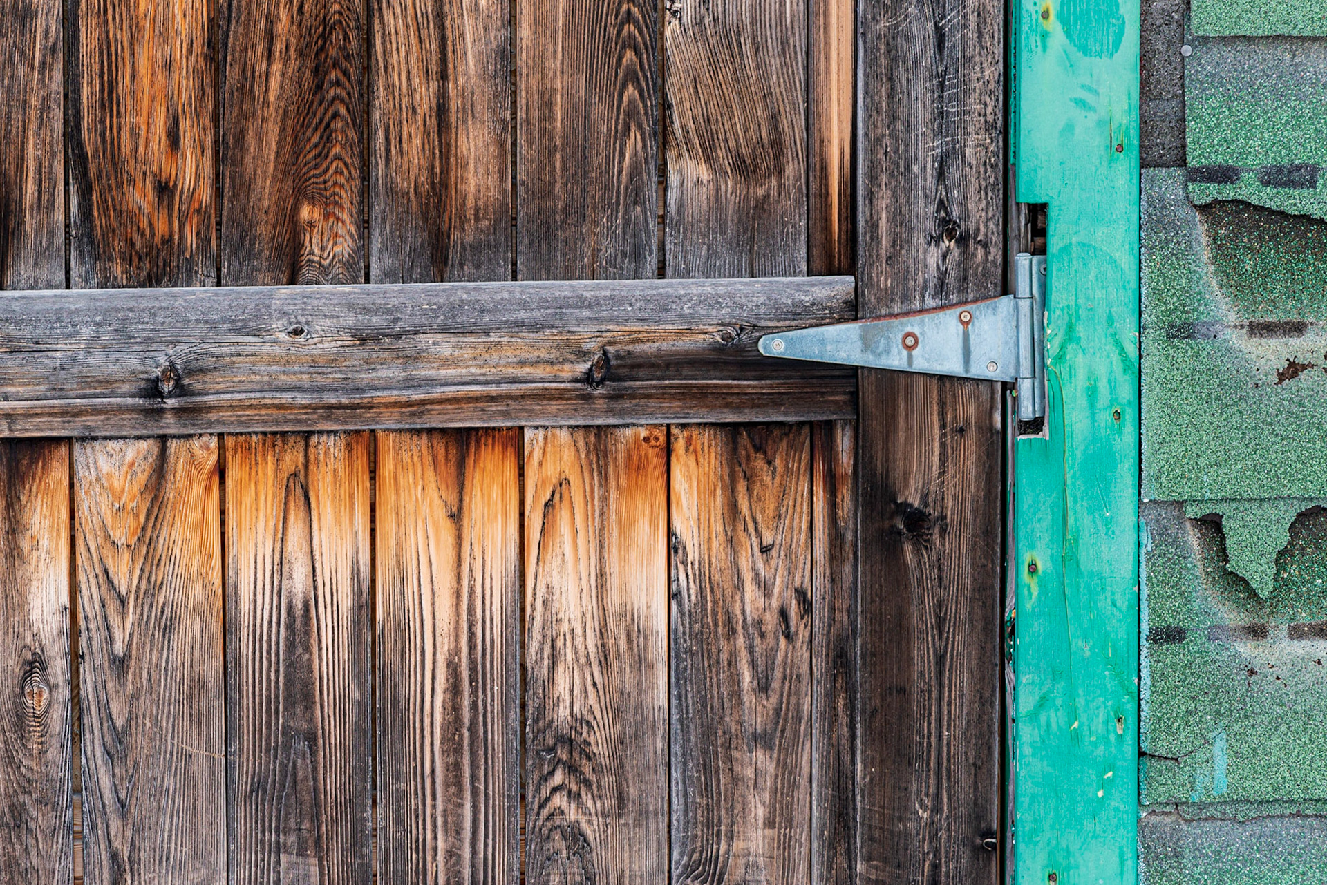 Horizontal and vertical lines with bright orange on the door arranged to balance with the strong green on the right. The silver door hinge serves as a center of interest as well as pointing into the frame.