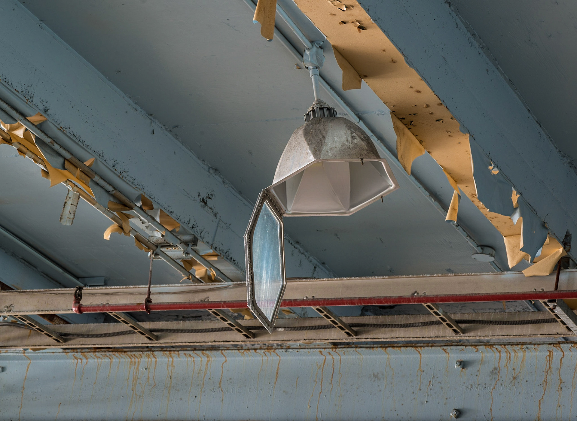 I love the shape and the light being reflected by this old fixture, amongst the general state of decay of the ceiling