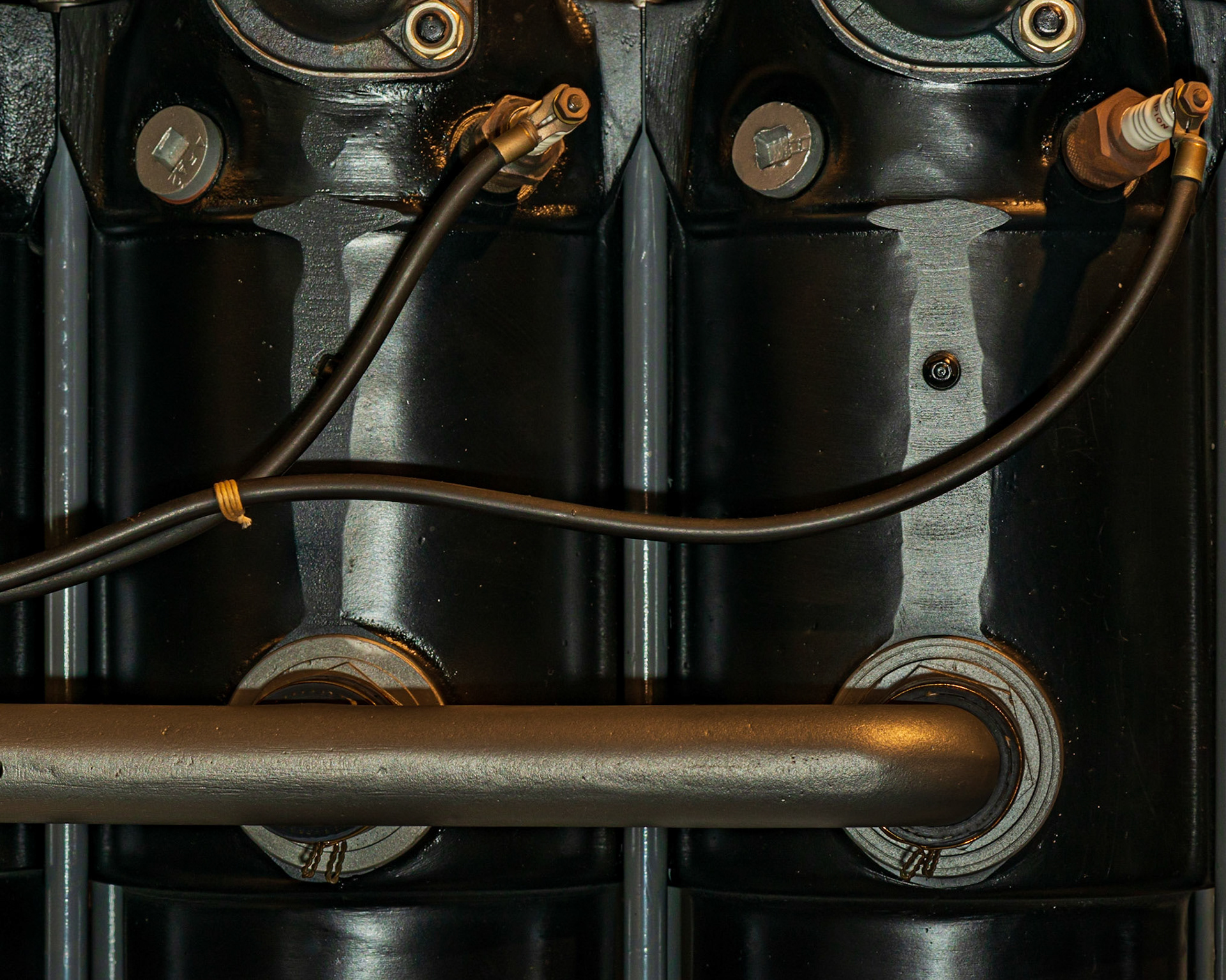 The fluid curves of the spark plug cables drew my eye to this shot. These contrast with the solidity of the vertical cylinders (particularly the silvery sections) and the horizontal pipe.