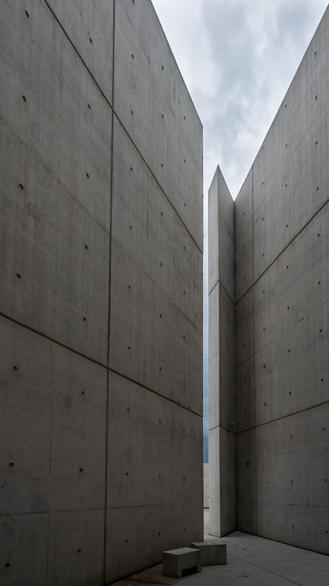 Diagonal and vertical lines. The seating rectangles add a focal point at the base of the image and help to balance the light triangle of sky at the top.