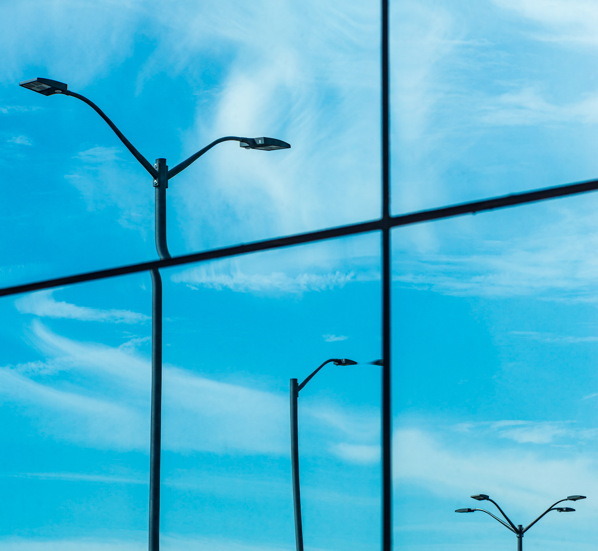 As I walked around the outside of the museum, I noticed interesting distortions in how the windows of the museum reflected the outside world, and in particular these lights from the parking lot.