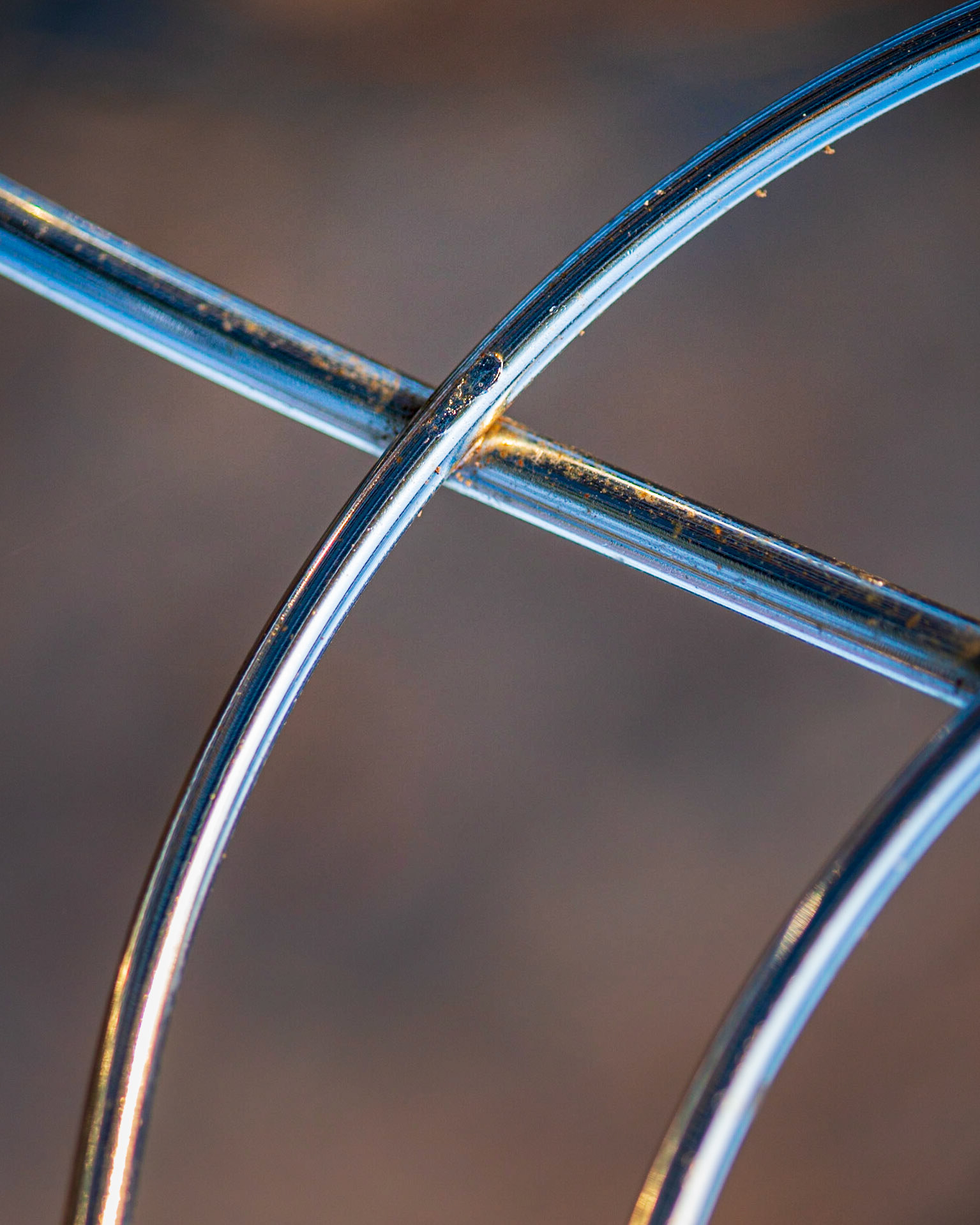 The metal frame of a chair. I took several shots of this chair since I felt it had lots of photographic potential. I used a narrow depth of field to blur the background and emphasize its graphic qualities.