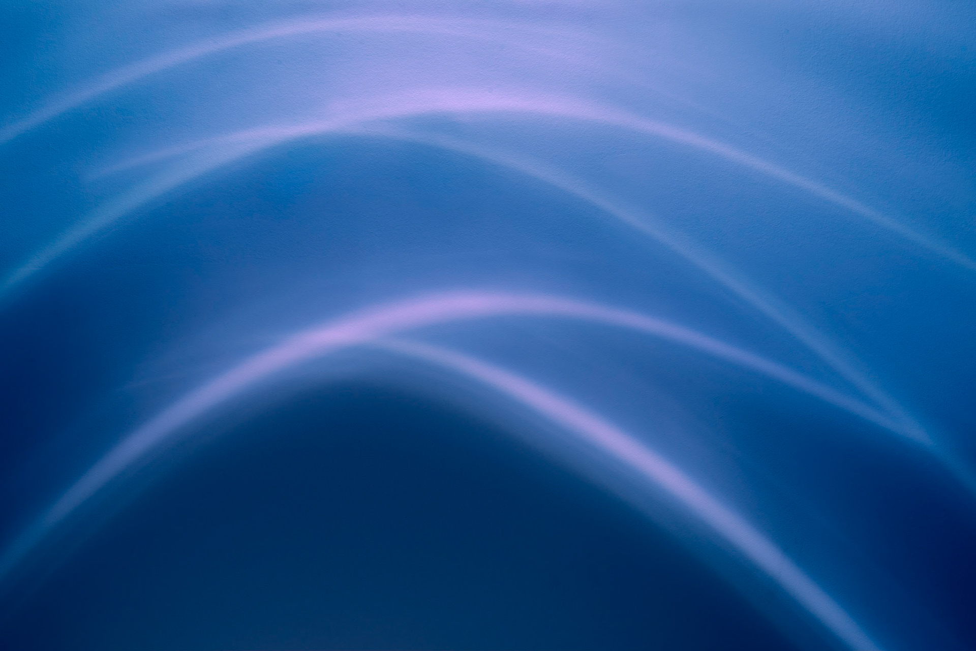 I have taken great liberty to change the colours in this shot of patterns on a wall created by recessed lighting.