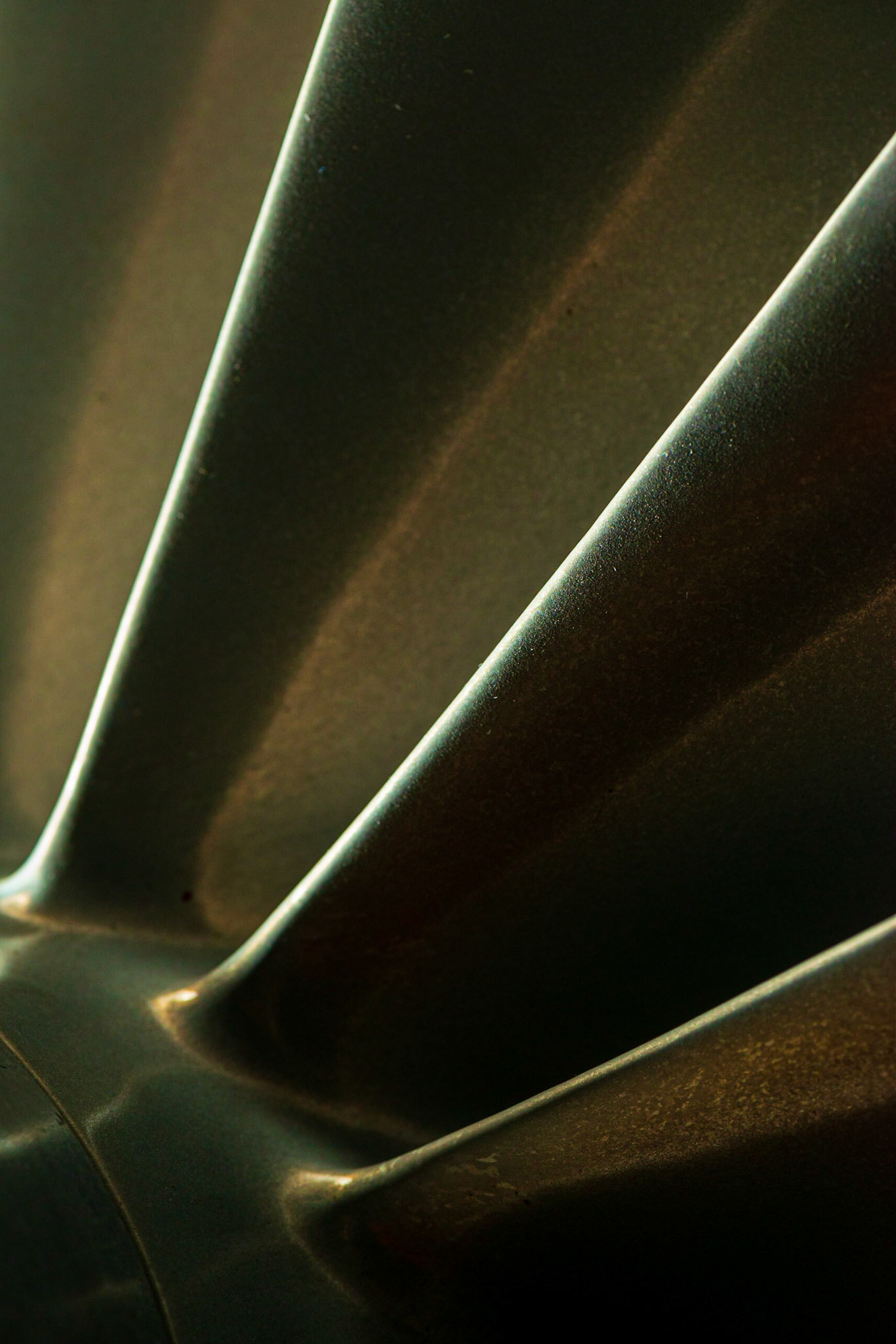 This shot is all about diagonal lines, with the green fins of the turbine contrasting with reddish areas from the overhead lighting. My flash to the side produced the edge highlights on the fins.