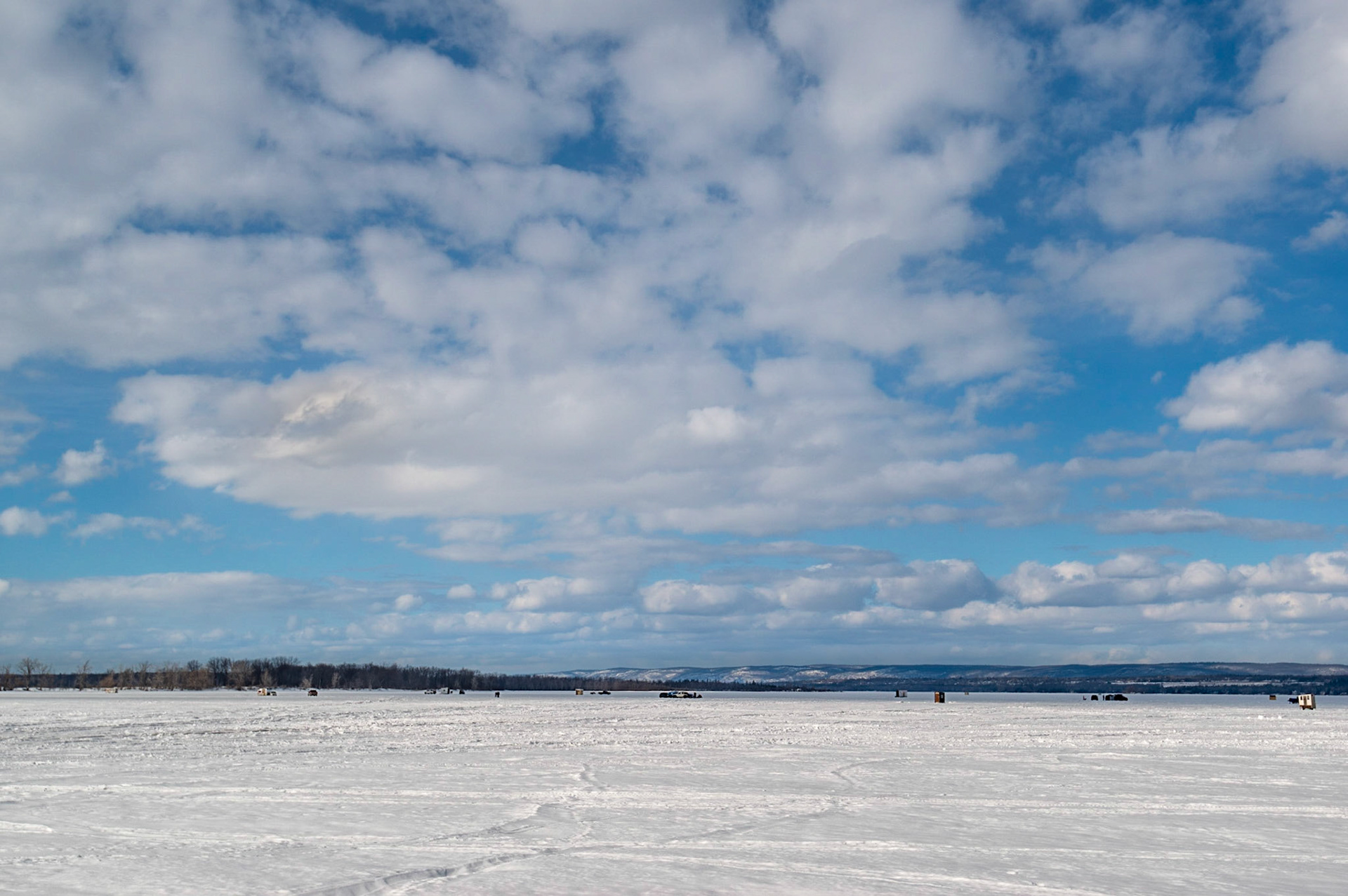Ice fishing is a popular sport during the Ottawa winters. Here, I've chosen a wide angle view to emphasize the landscape (and the distance of the fishing huts from shore)