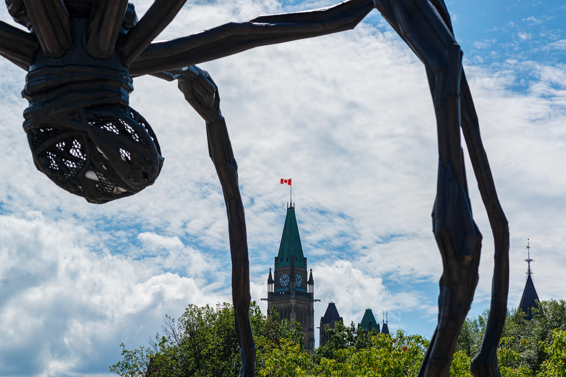 Here is a different view of the Maman sculpture with the Peace Tower of Canada’s Parliament in the background and the Canadian flag as a spot of red to draw the eye.