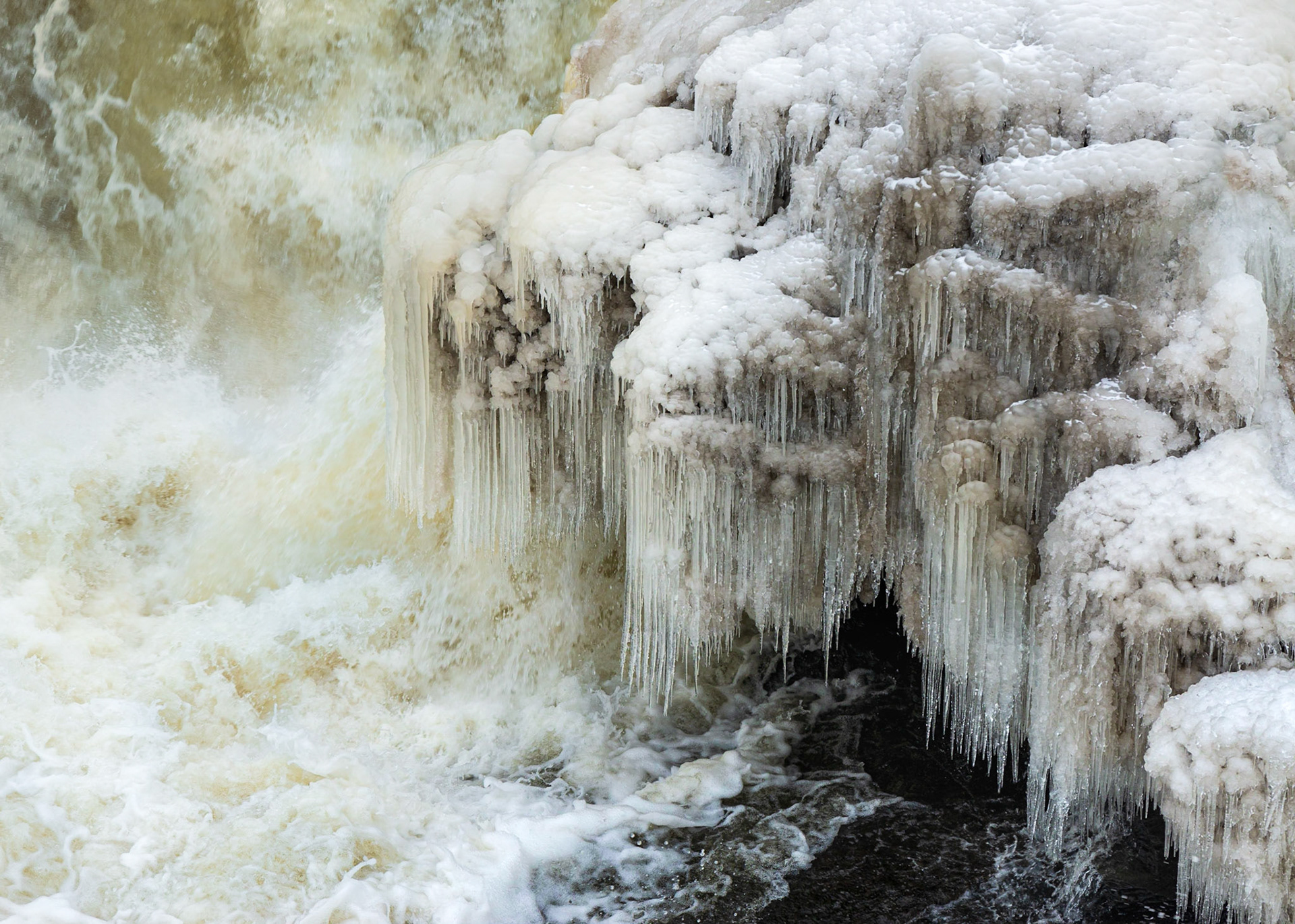 I took some shots to emphasize the power of the water coming over the falls and this is one. The main subject is the icicles in the context of the rushing water, and there is a nice diagonal from upper left to lower right, and a patch of calm water to contrast with the falls.