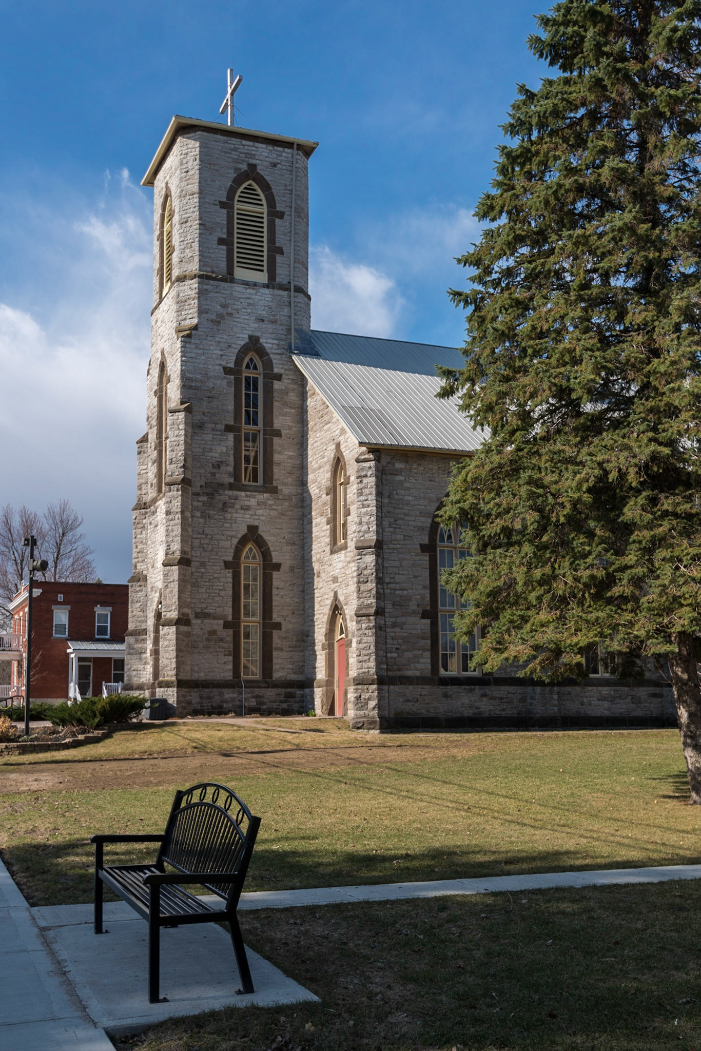 An attractive church in Almonte Ontario surrounded by grounds that are just starting to turn green after a harsh winter.