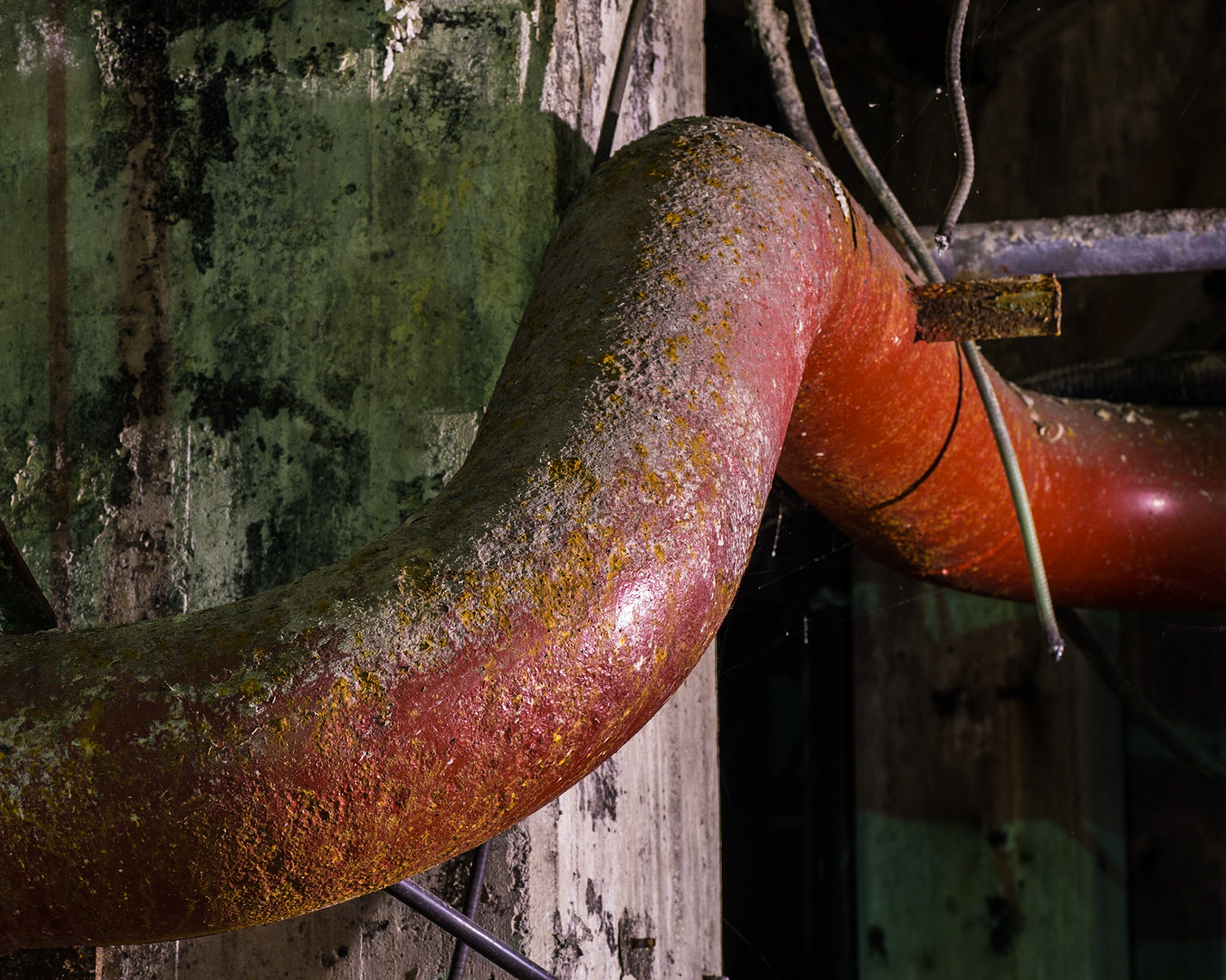 The shape of the red pipe set amongst the green shadows on the pillars caught my eye in this composition