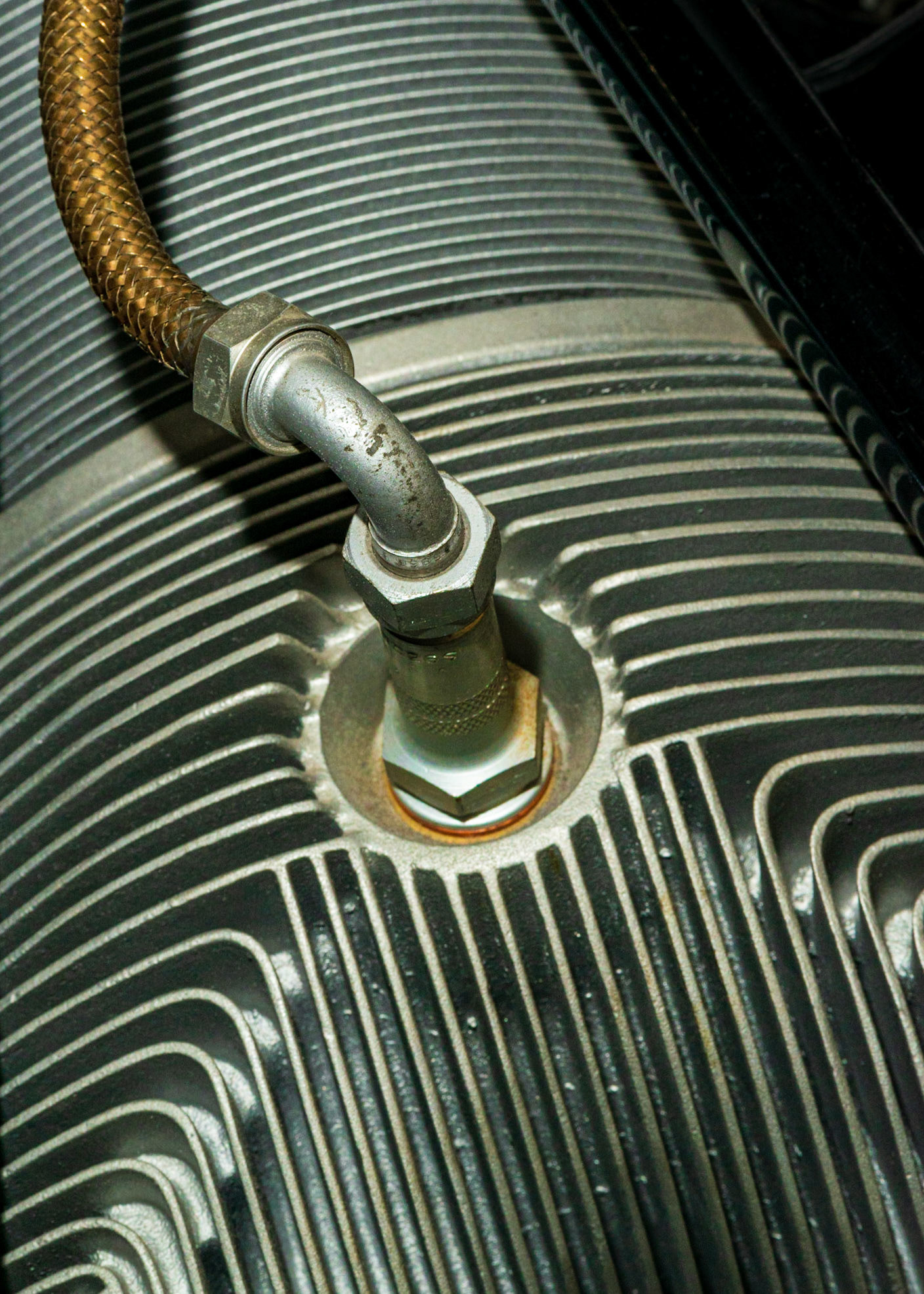 The many leading lines in this photograph draw our attention to the circular feature just off centre. The rust colour below the nut echoes the colour of the cable at the upper left.