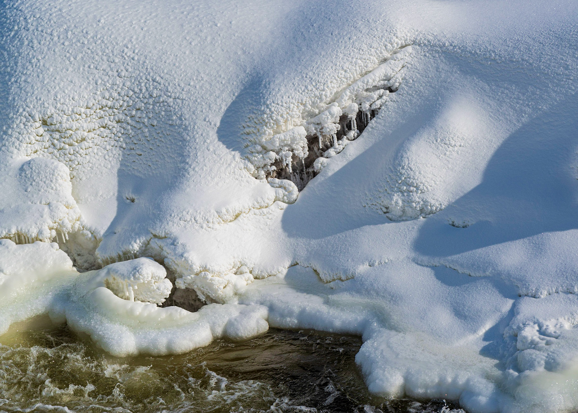 There are some nice diagonal lines in this shot formed by the ice cavity and the shadows. I particularly like the soft flowing shapes and texture of the snow.