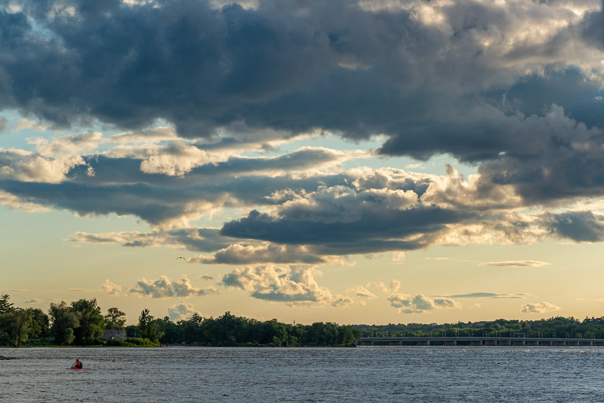 A lone kayaker with the Champlain Bridge in the background. I'm contrasting the tiny kayaker with the immense sky that fills most of the frame.