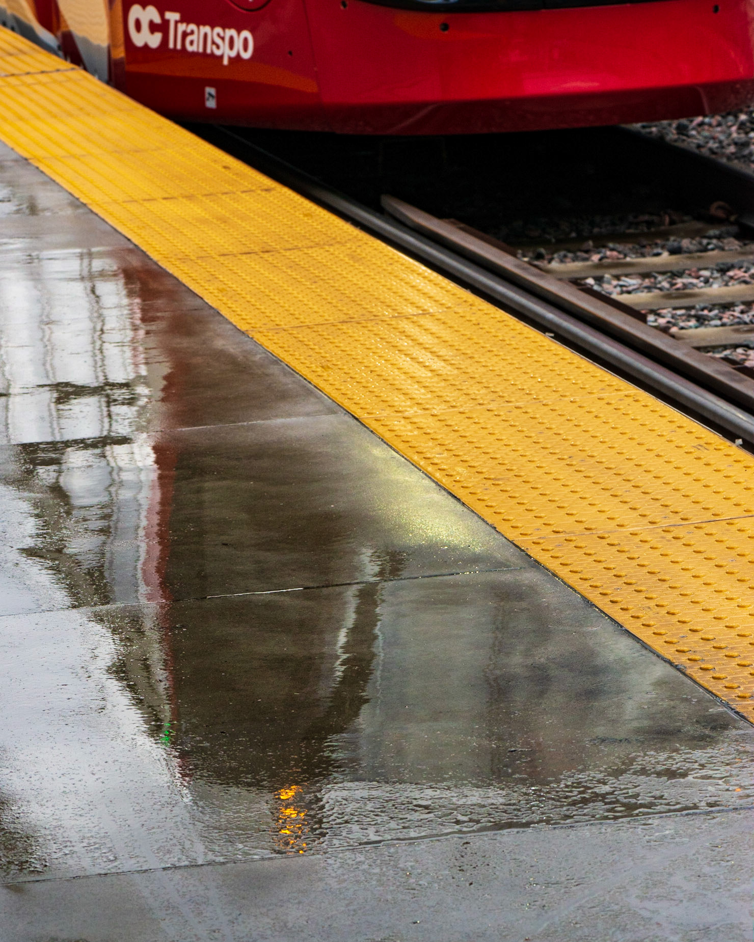 Tremblay Station. Rather than photographing the LRT train directly, I saw a puddle and chose to work with its reflection instead. I’ve only left a sliver of the train at the top to give context to the photo.