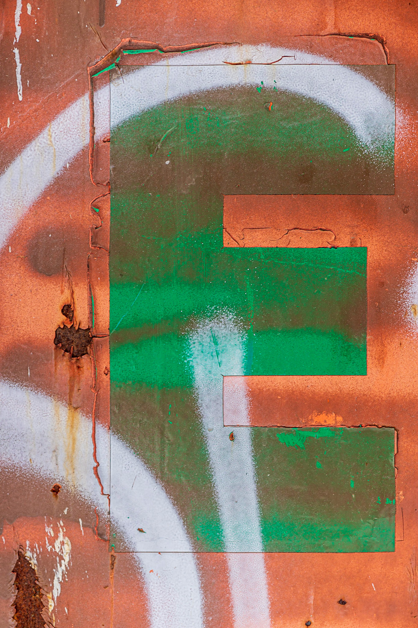 Found on the side of a dumpster. The green “E” stands out on the contrasting background of orange/red, and the sweeping strokes of white add dynamism to what would otherwise be a static image.