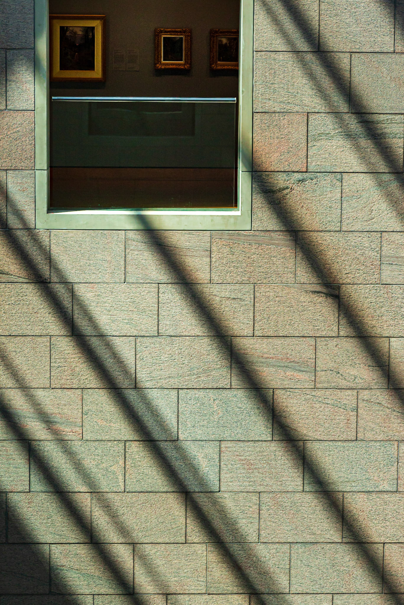Courtyards within the Gallery are filled with natural light during the day and on bright days there are strong shadows cast by the frame of the skylight. Here, I’ve combined these shadows with a view of the Gallery contents through a courtyard window.