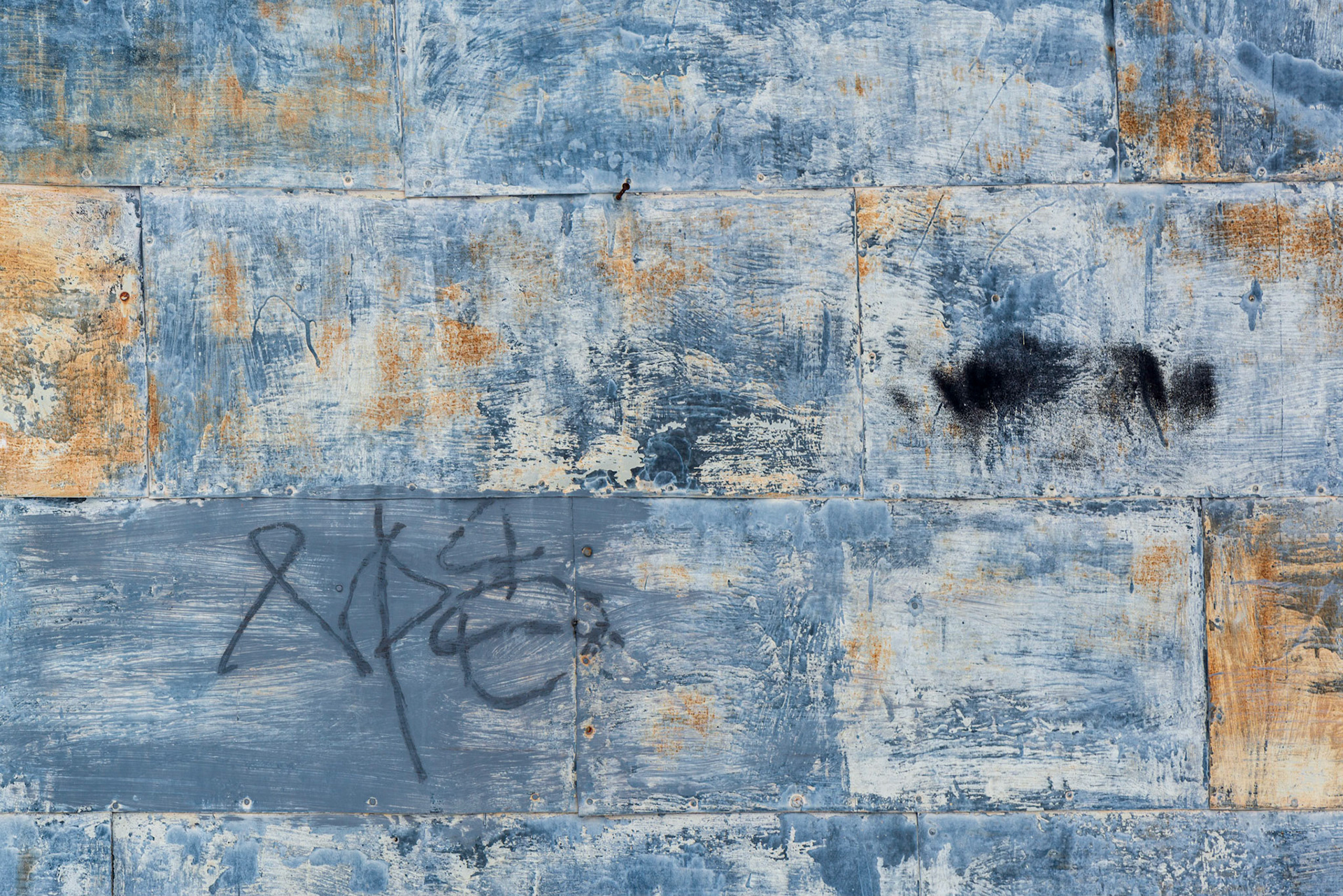 The graffiti caught my eye along with the yellow/blue contrasting colours. I sought a composition where the graffiti and the smudge of black paint, and the areas of yellow on the left and right boarders were balanced in the frame.