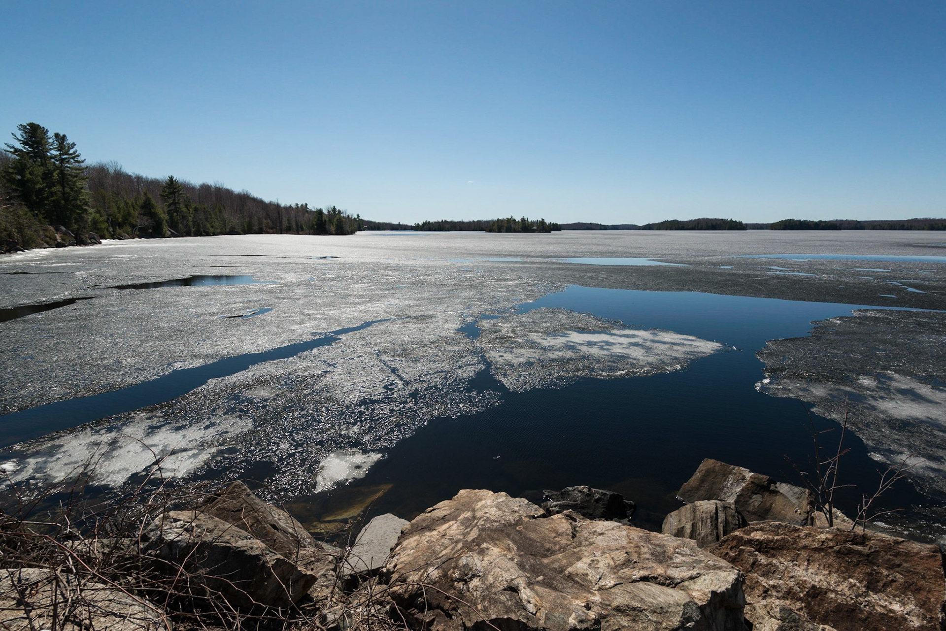 Backlit ice breaking up on Sharbot Lake photographed near the causeway