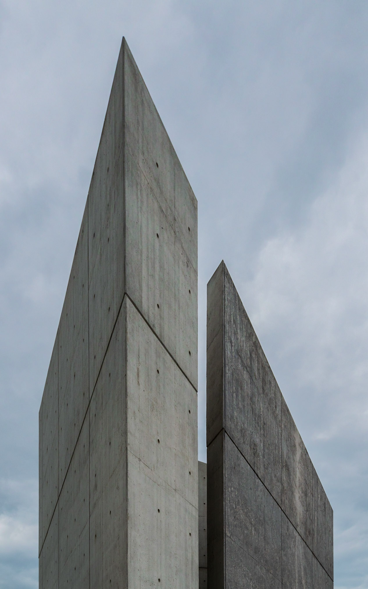 Vertical shapes set within a blue background.
