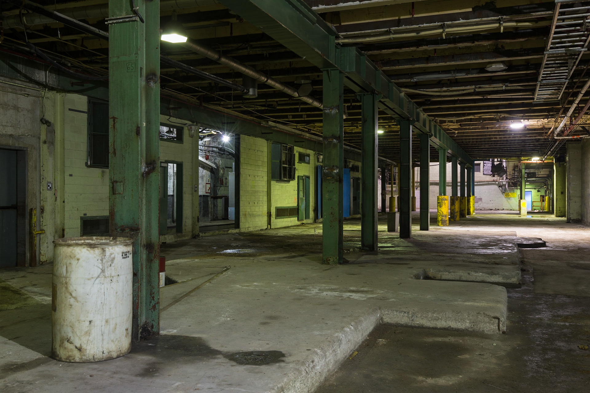 While the area now stands open, the indented concrete floor suggests this area once held large objects