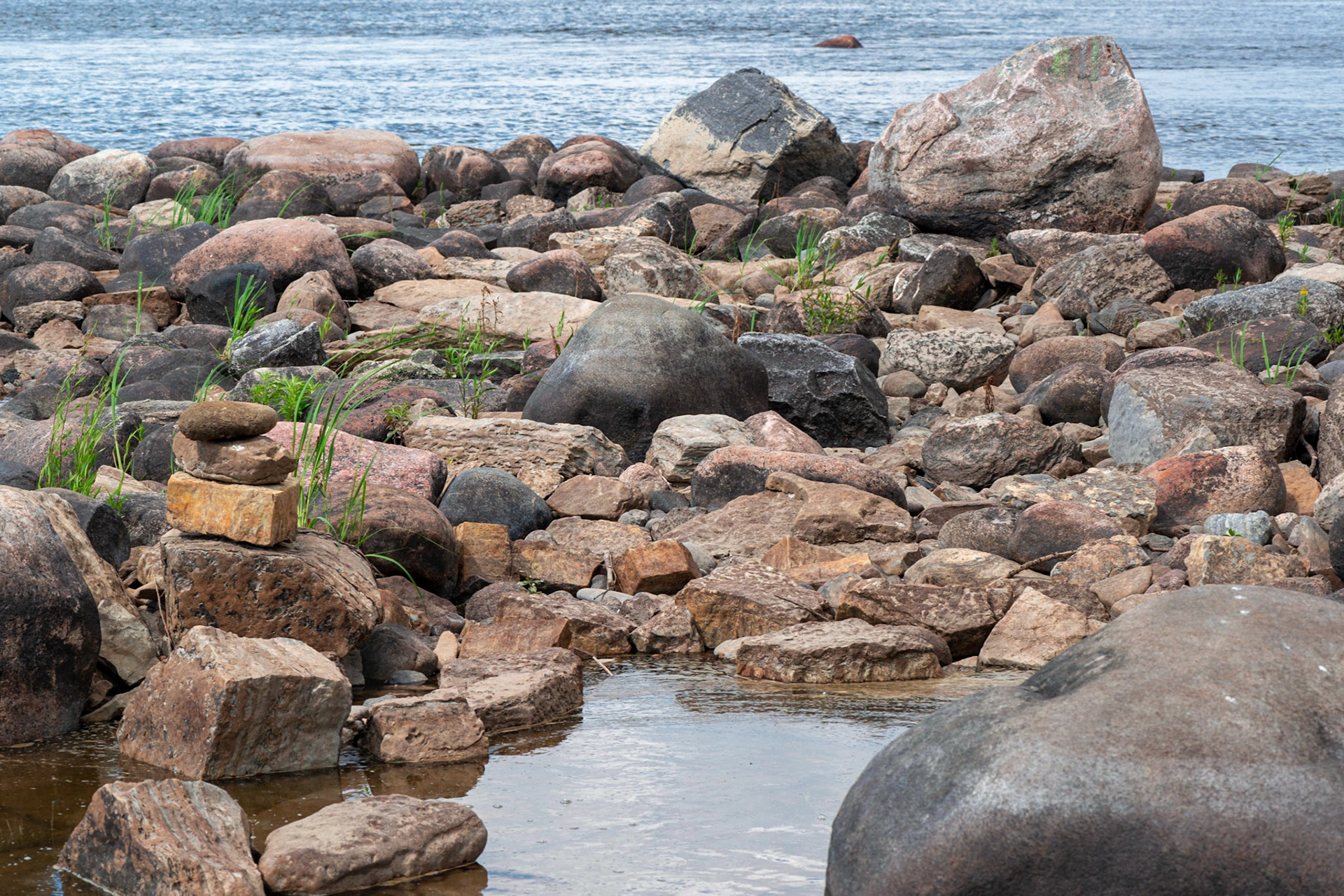 A view from the shoreline. Someone had been playing with the rocks, and I wanted to include that as a point of interest. Likewise, the framing was chosen to include the lone rock in the river.