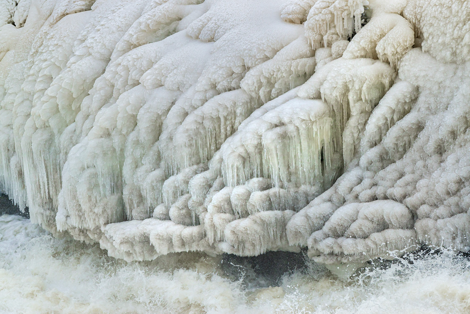 One of many ice formations at Hog’s Back Falls. In this case, I was attracted to the icicles just right of center, and to the many upwardly sloping diagonal lines in the ice. I included a small amount of water, and the splash in the corner, to provide context.