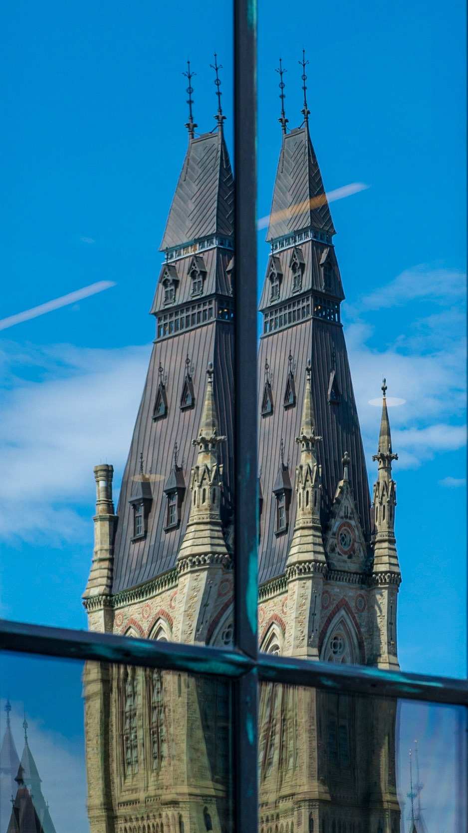 The glass on the Bank of Canada building reflects the buildings on Parliament Hill, but depending on where you stand you can sometimes get a double reflection as in this shot.