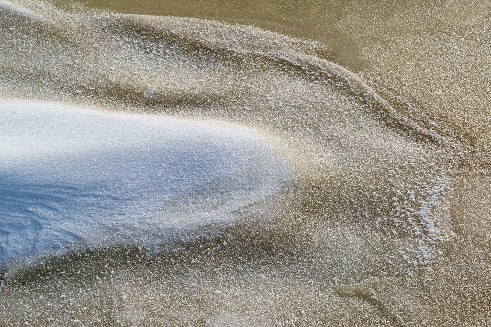 I love colour contrasts, particularly blue and yellow. Here, the underlying ice is yellowish while a layer of snow catches the sky's blue hue. The shape of the snow mound is also echoed in the ice.