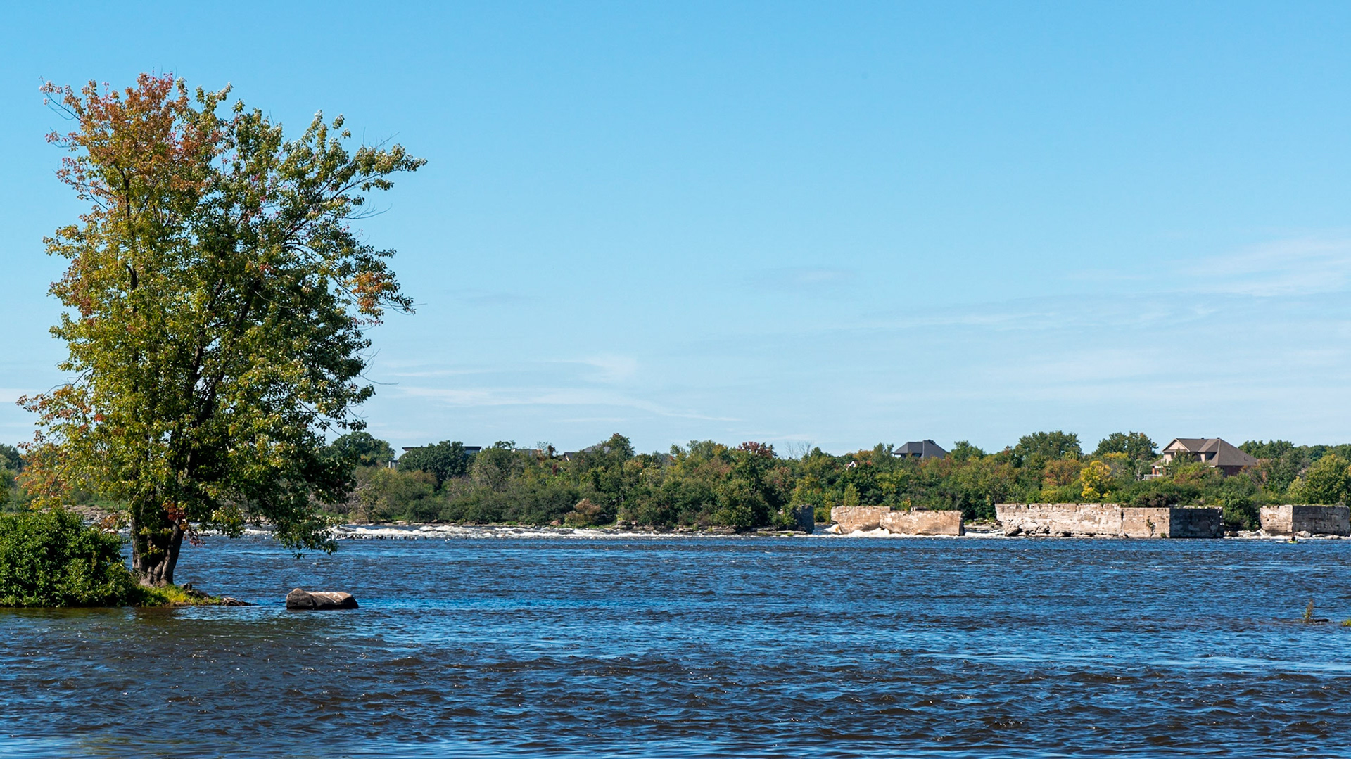 Ruins of the former Alymer hydro dam, alongside the Deschenes rapids, as seen from the Ottawa side of the river.