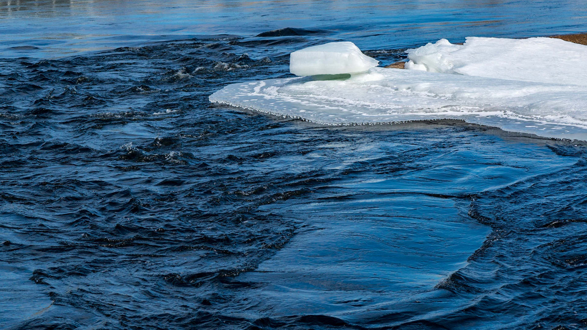 An interesting block of ice suspended above an ice flow. I was aiming for a fairly simple composition with a lot of negative space represented by the water.