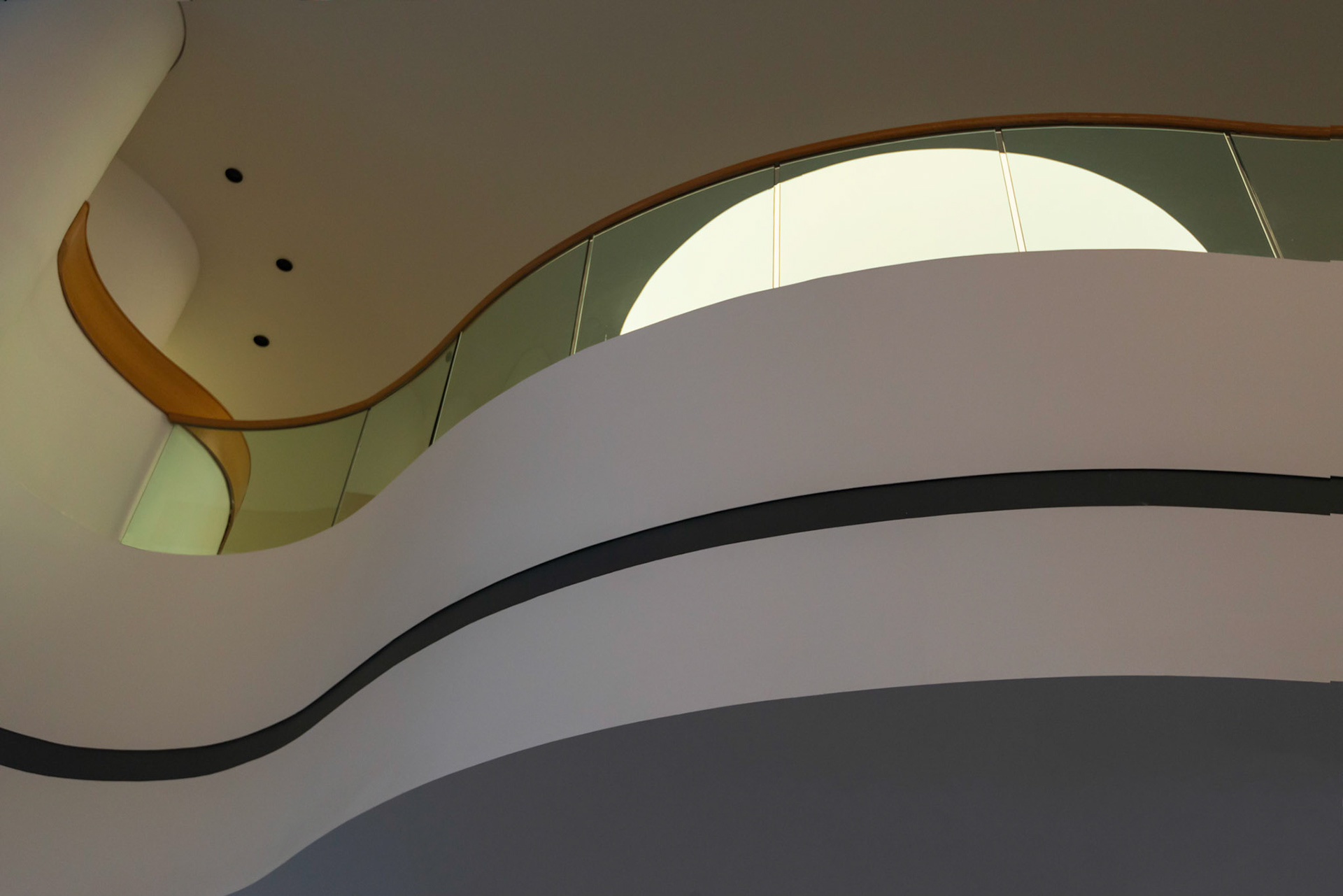 I placed the dominant half-moon shape within a series of flowing horizontal lines. The three black dots at the upper left were retained to balance the composition.