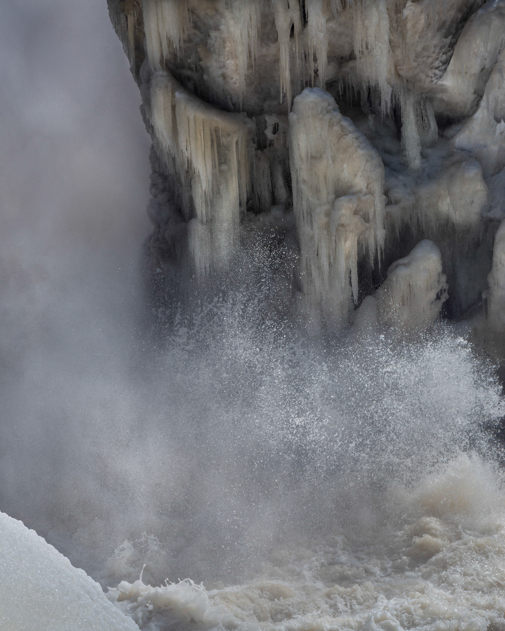 I see a face in this ice formation; do you? The "expression" of the face together with the spray of water make this photo for me.