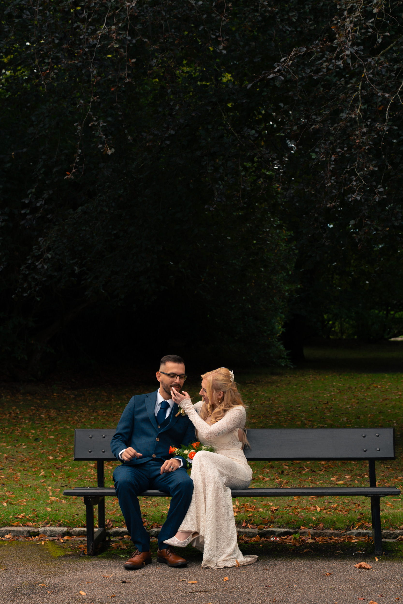 Duthie Park Winter Gardens wedding: Couple sit on a bench, chatting.